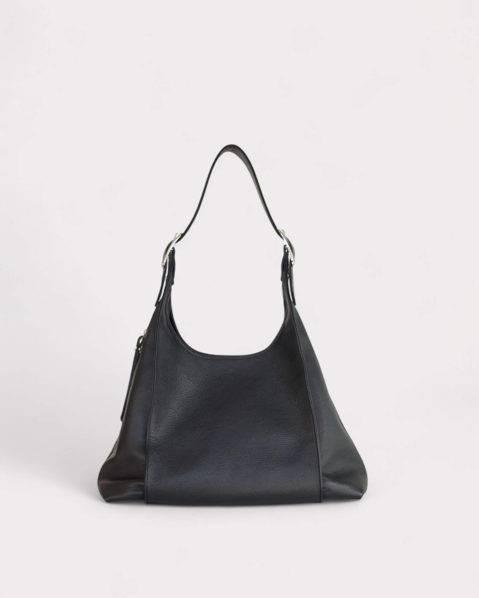 Black leather handbag on a light gray background