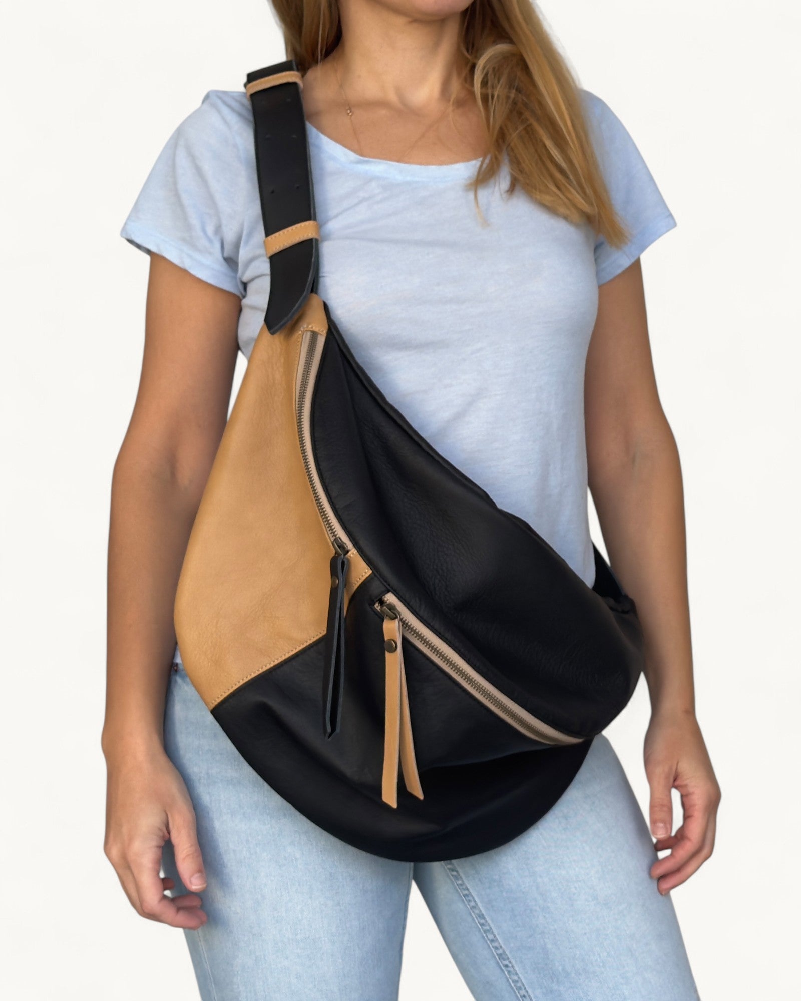 Person wearing a black and tan fanny pack bag on a white background