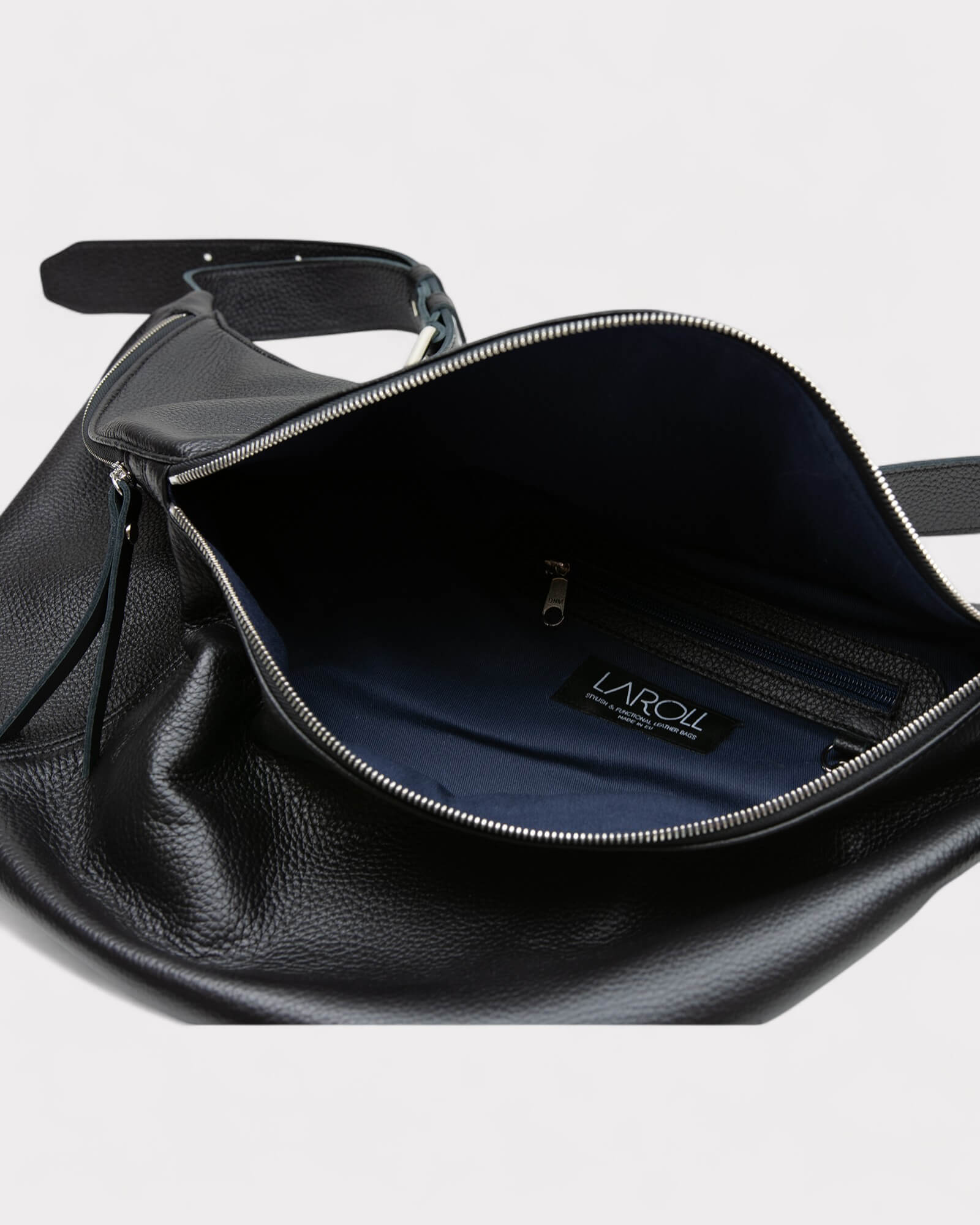 Black leather bag with a visible brand label on a light gray background