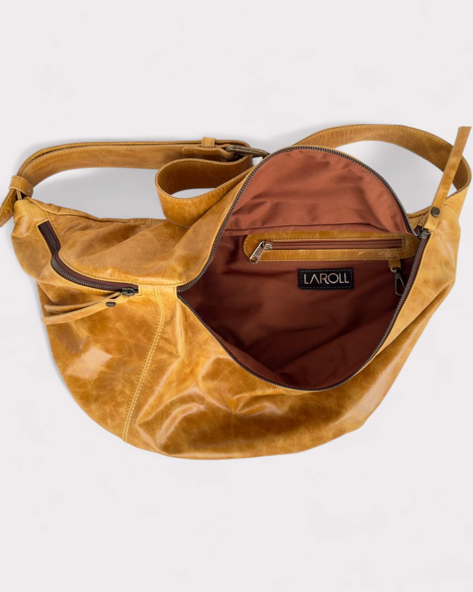 Tan leather bag lining color with visible brand logo on a light gray background