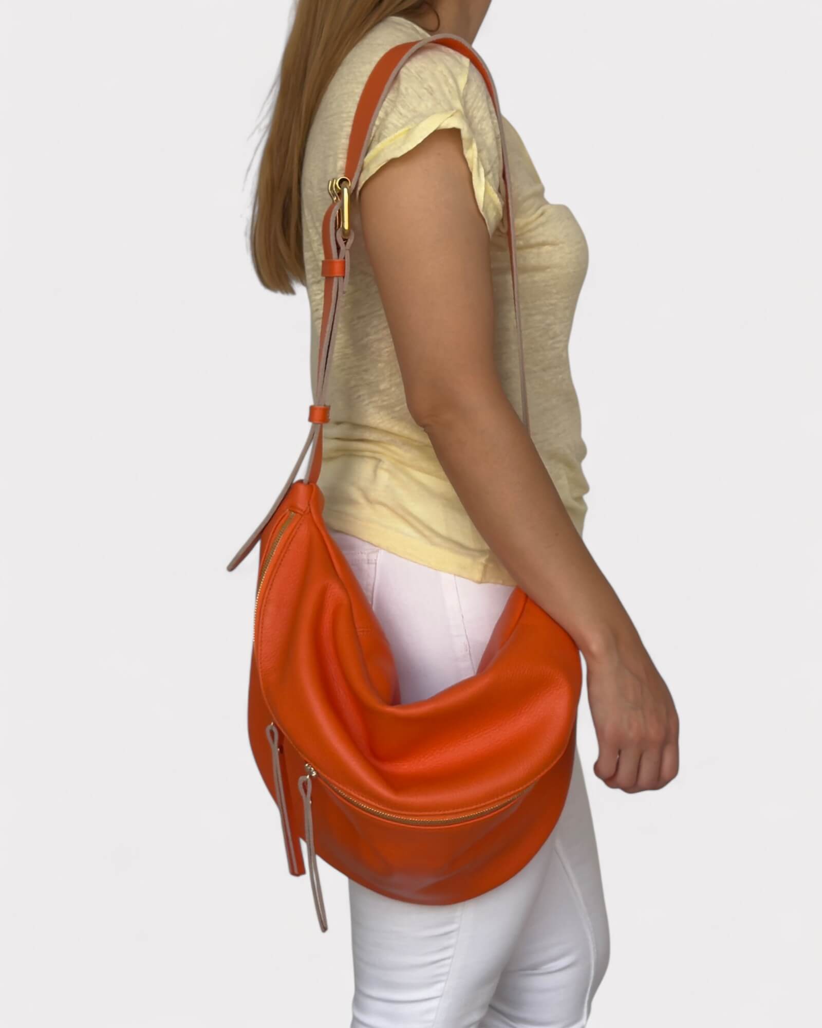 Person wearing an orange belt bag on a white background