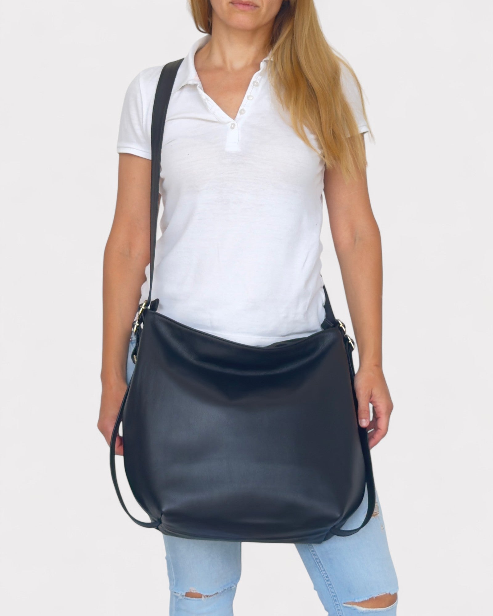 Person wearing a black shoulder bag on a white background
