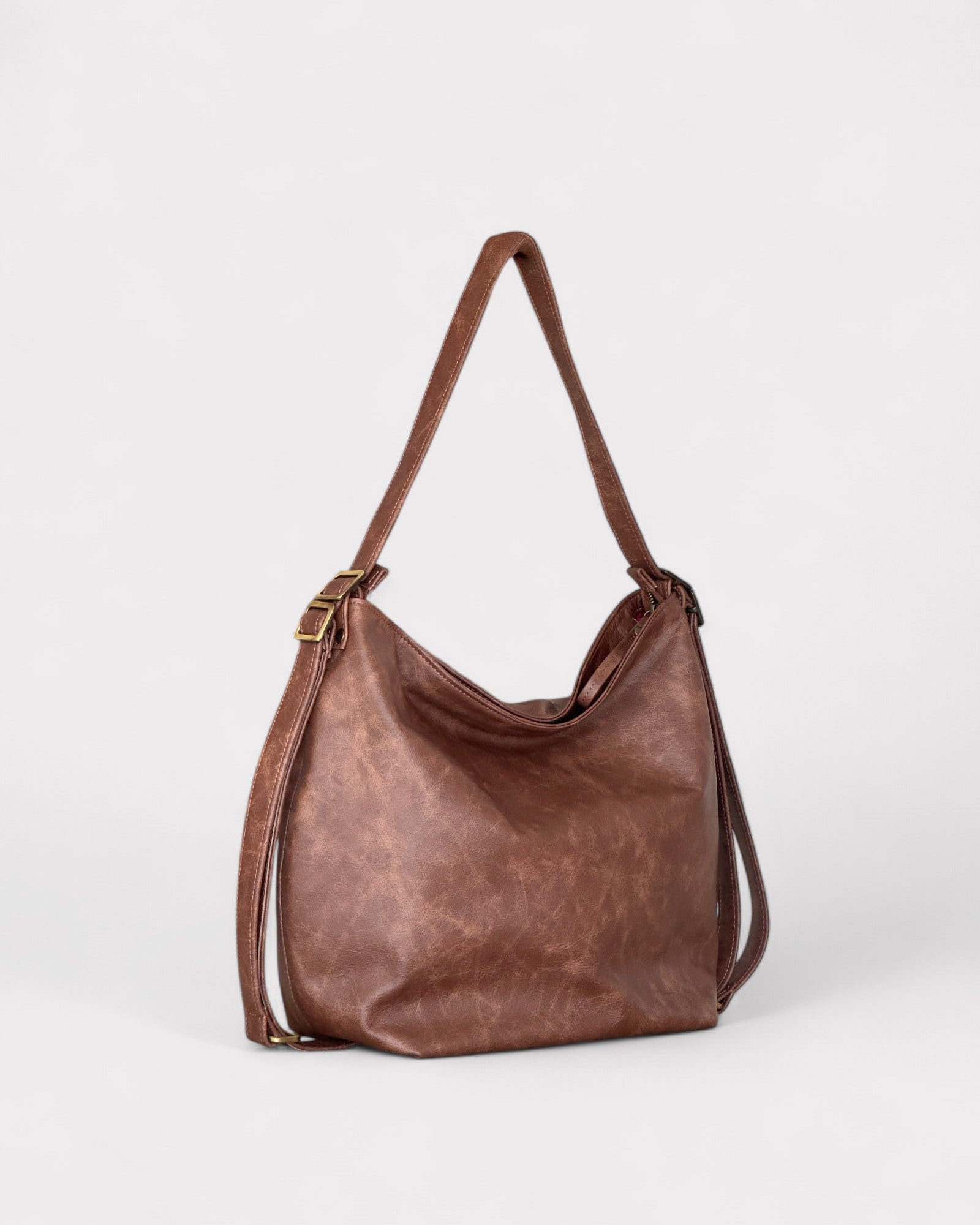 Brown leather handbag on a light gray background