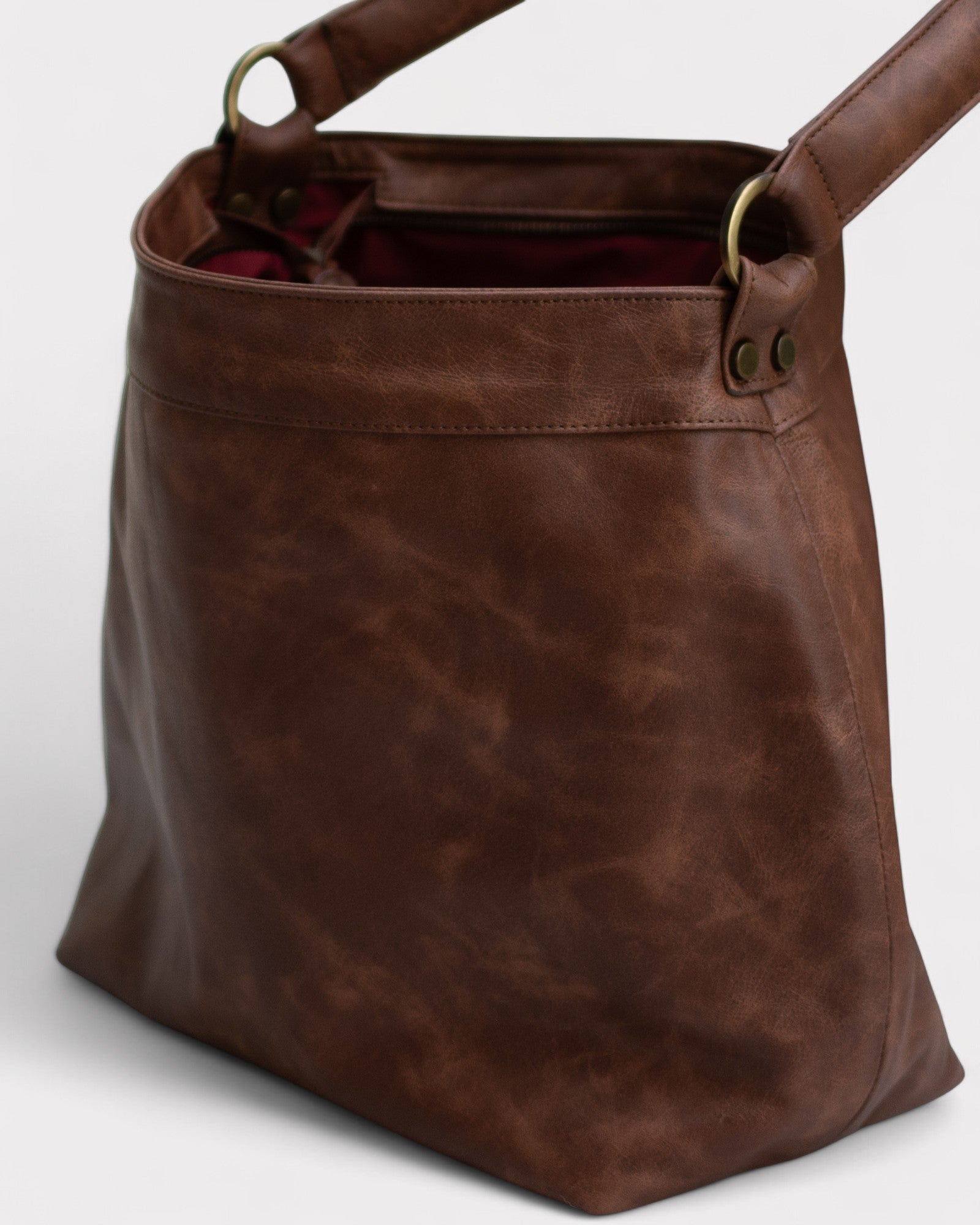 Brown leather tote bag on a white background