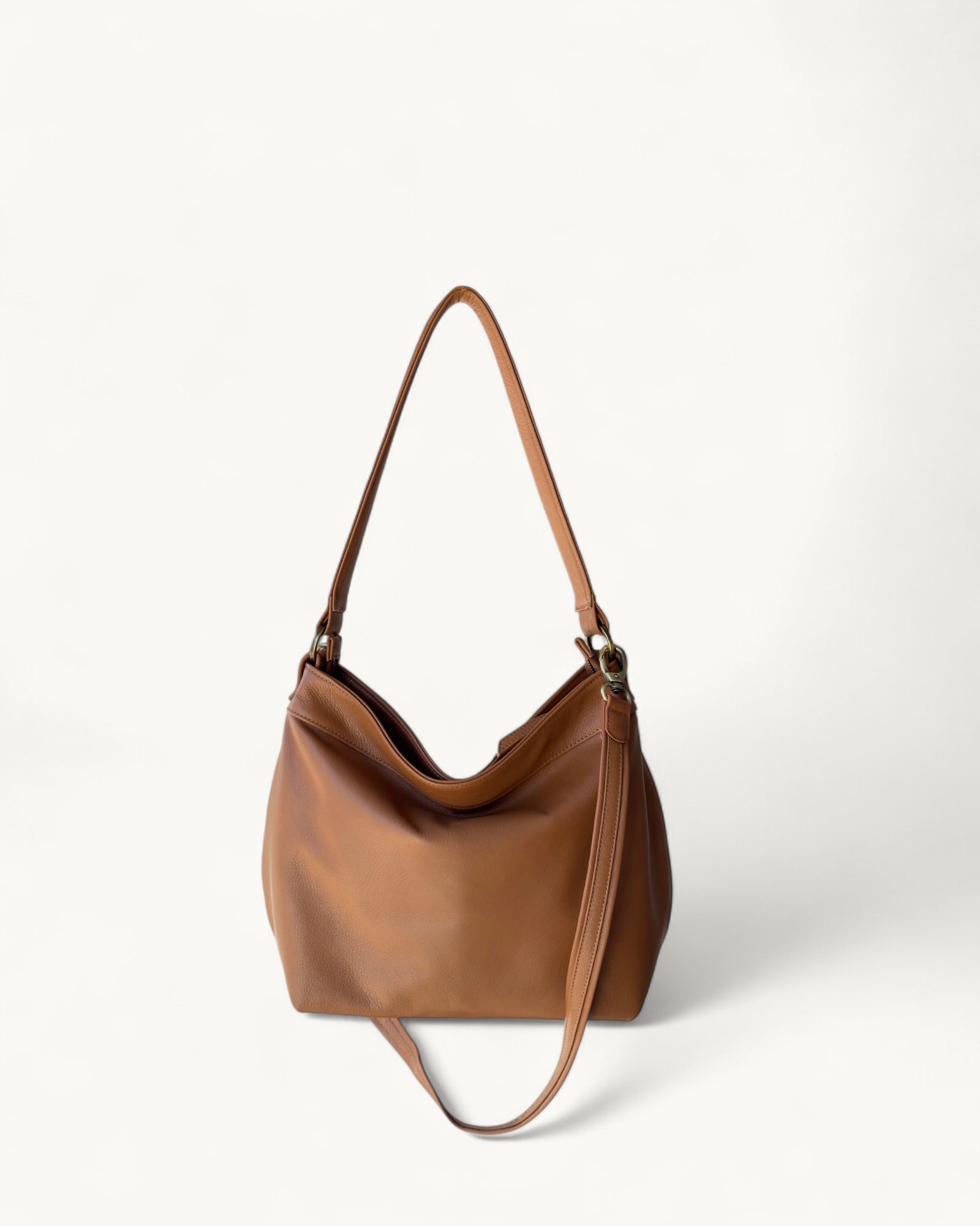 Tan leather handbag on a white background