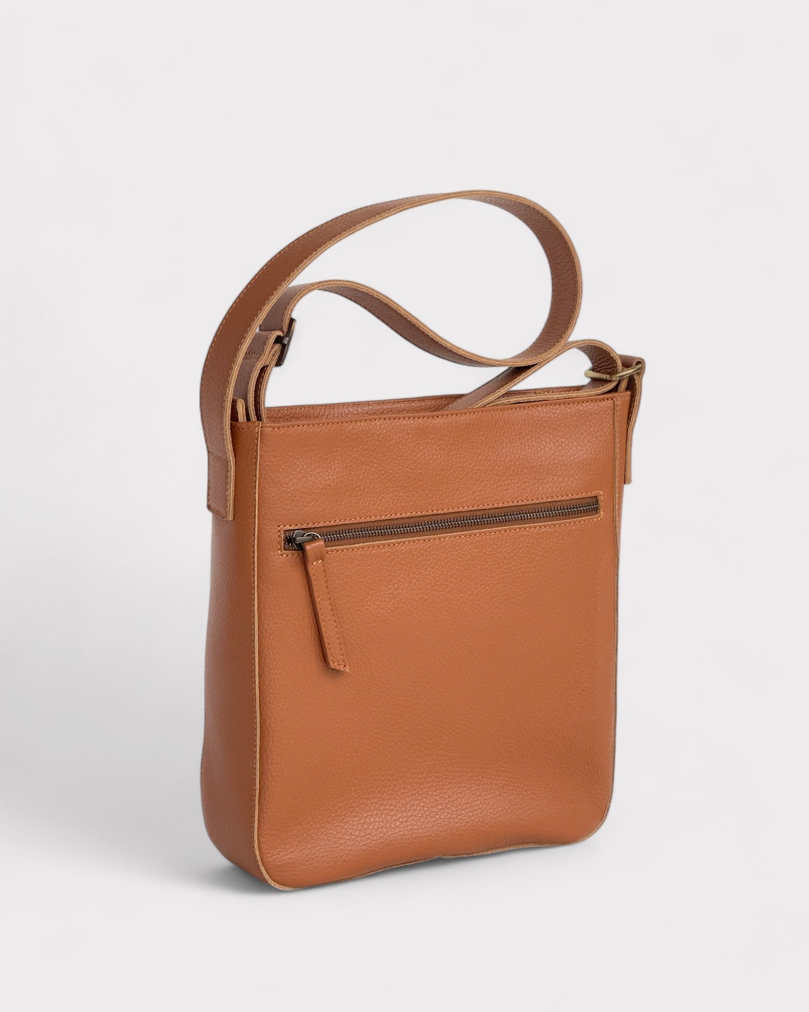 Tan leather crossbody bag on a light gray background