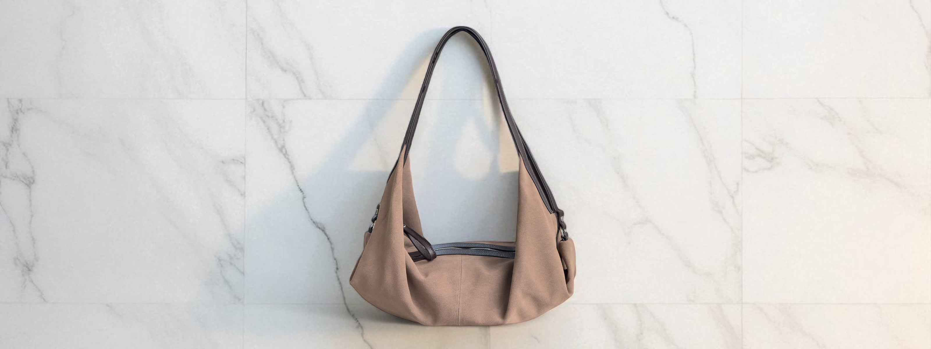Taupe handbag on a light marble background