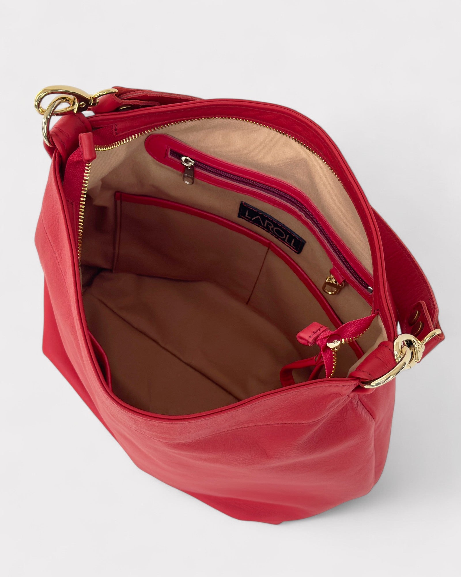 Red handbag with gold accents on a light gray background