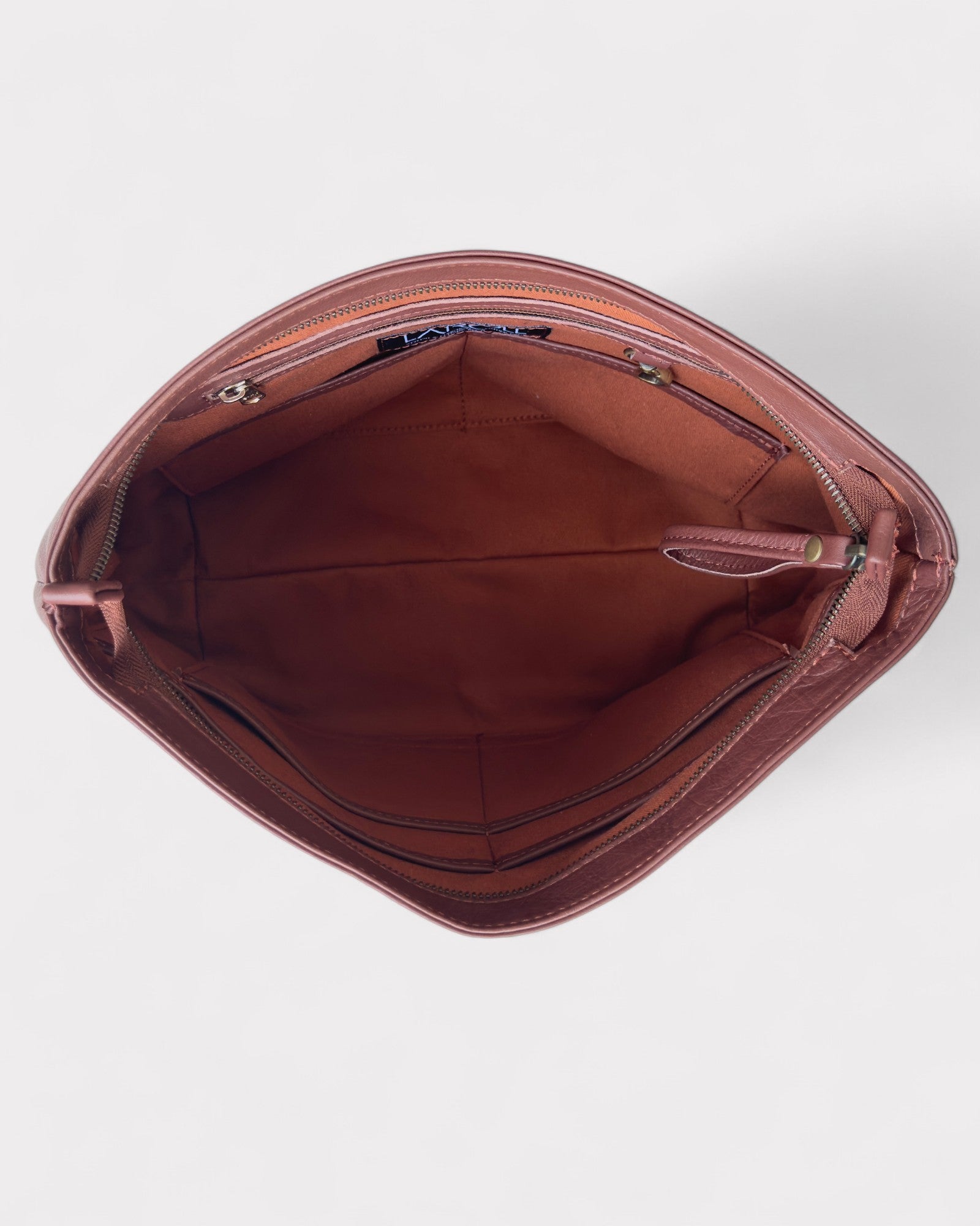 Brown leather bag with open interior on a white background