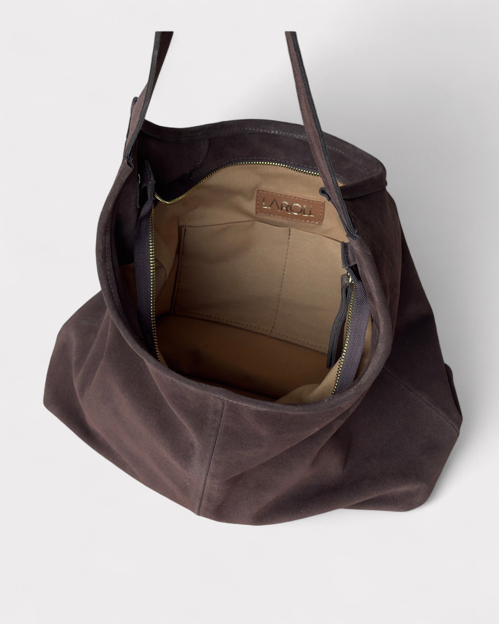 Brown leather handbag with visible brand logo on a white background