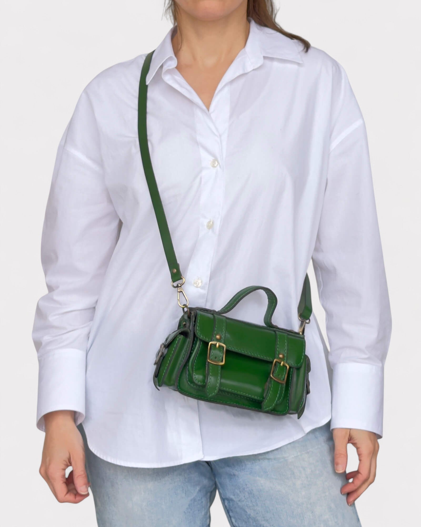 model carrying green satchel across the body