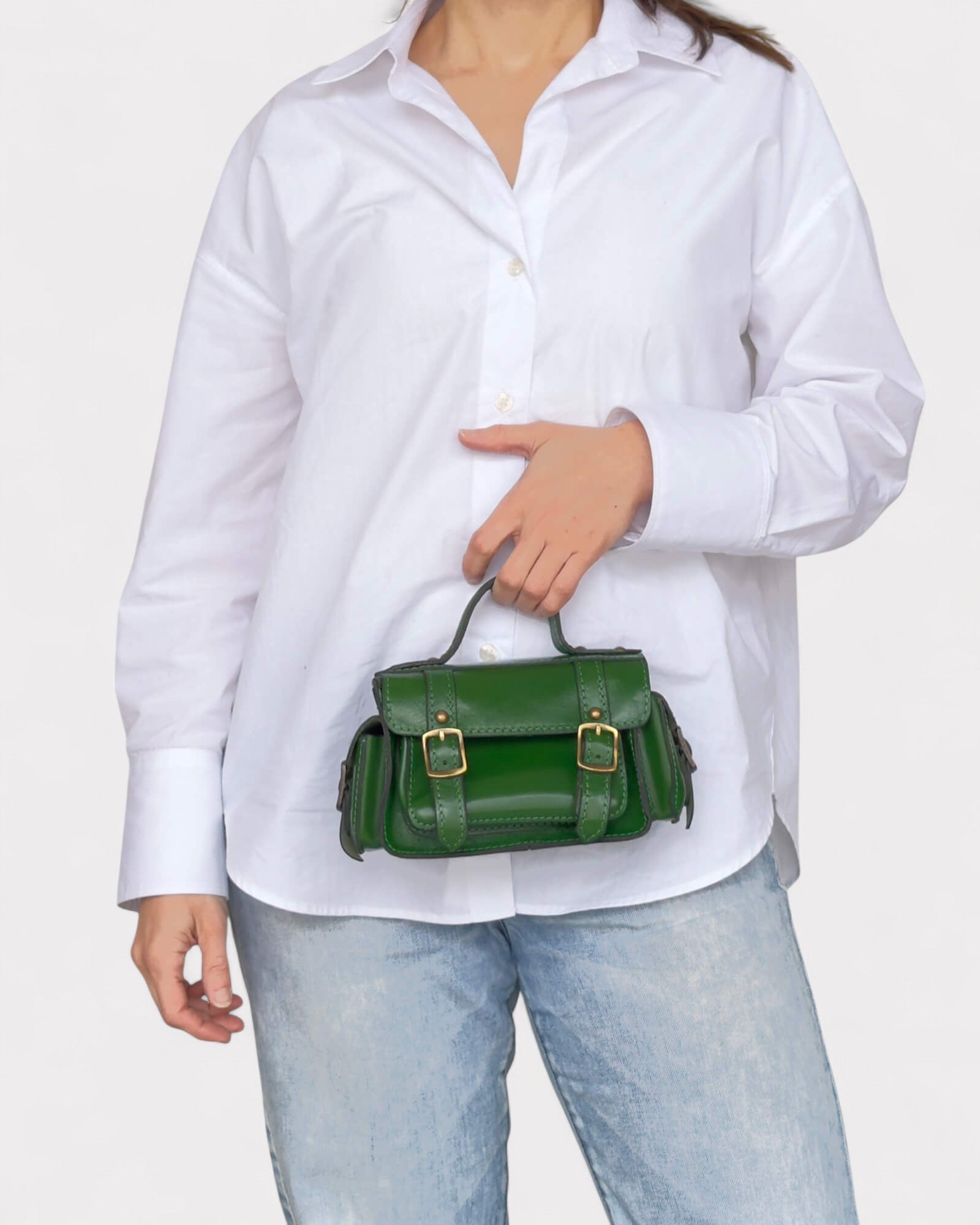 model carrying green satchel crossbody bag