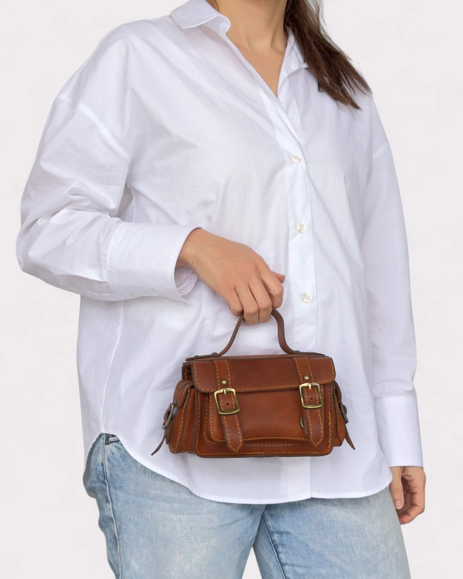 model carrying the brown crossbody satchel