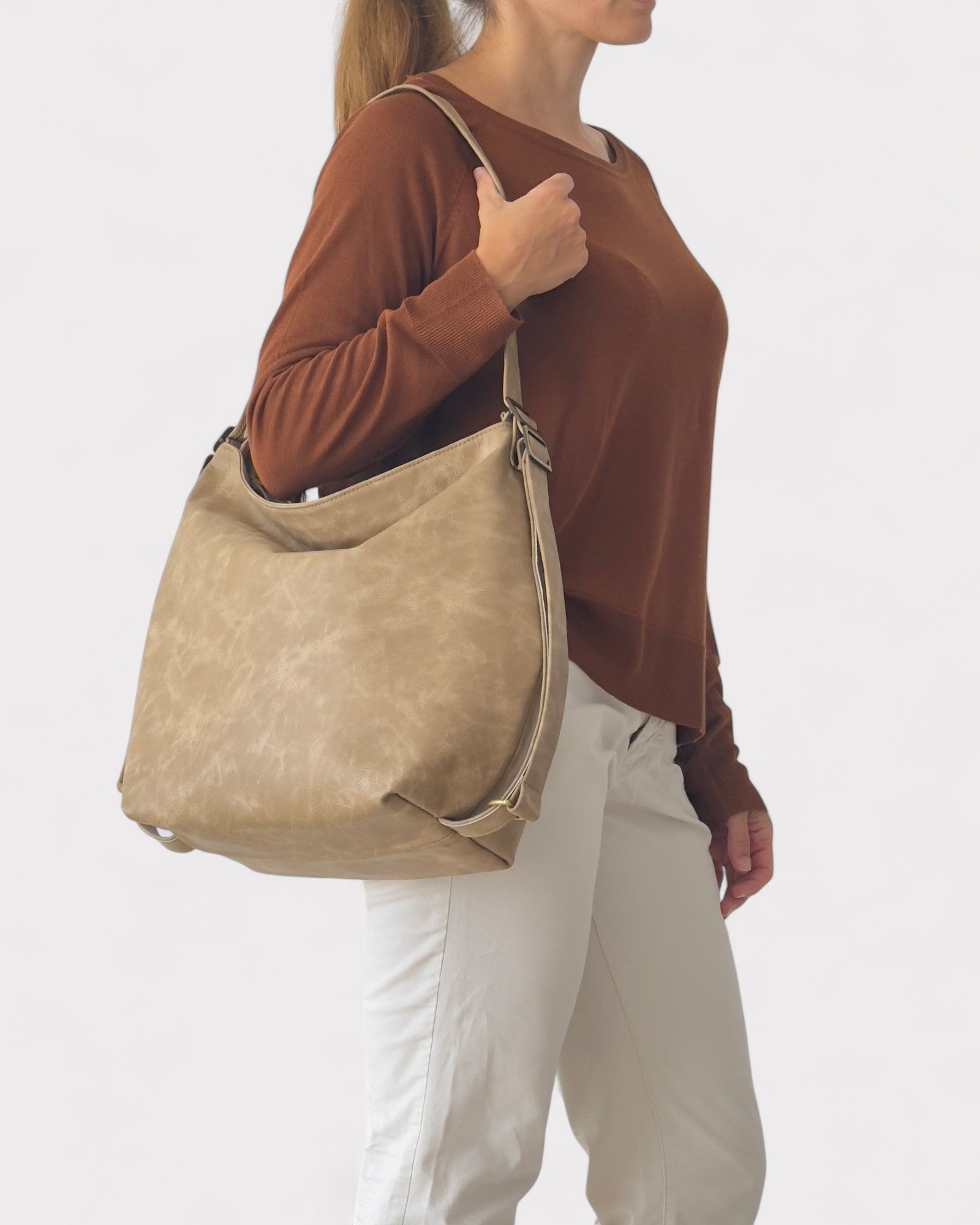 model wearing convertible hobo bag on shoulder