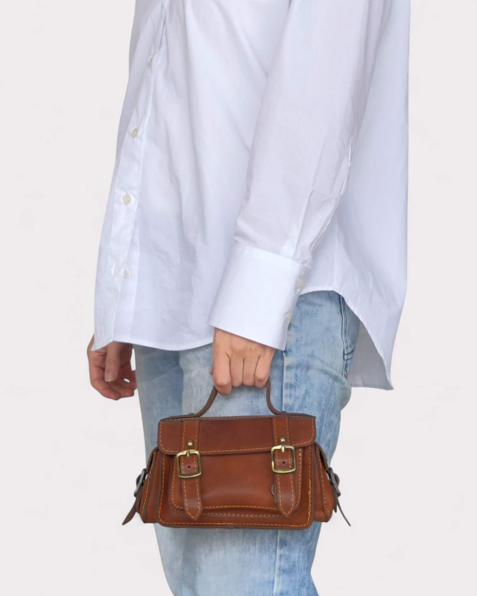 model wearing the brown crossbody satchel