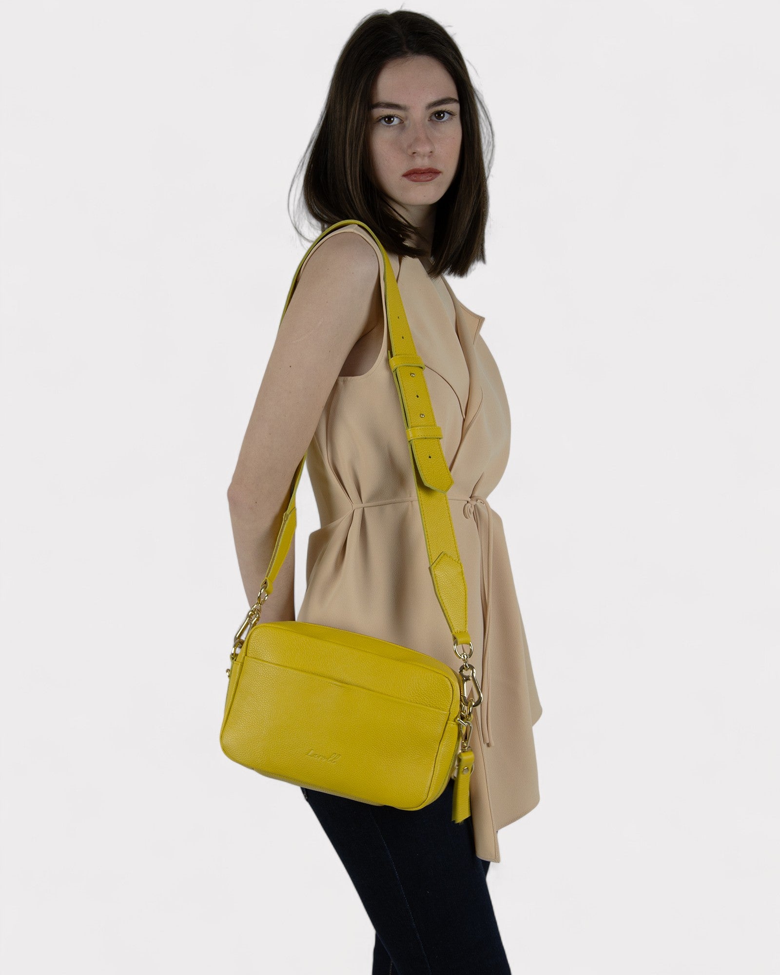 woman wearing yellow camera bag side view