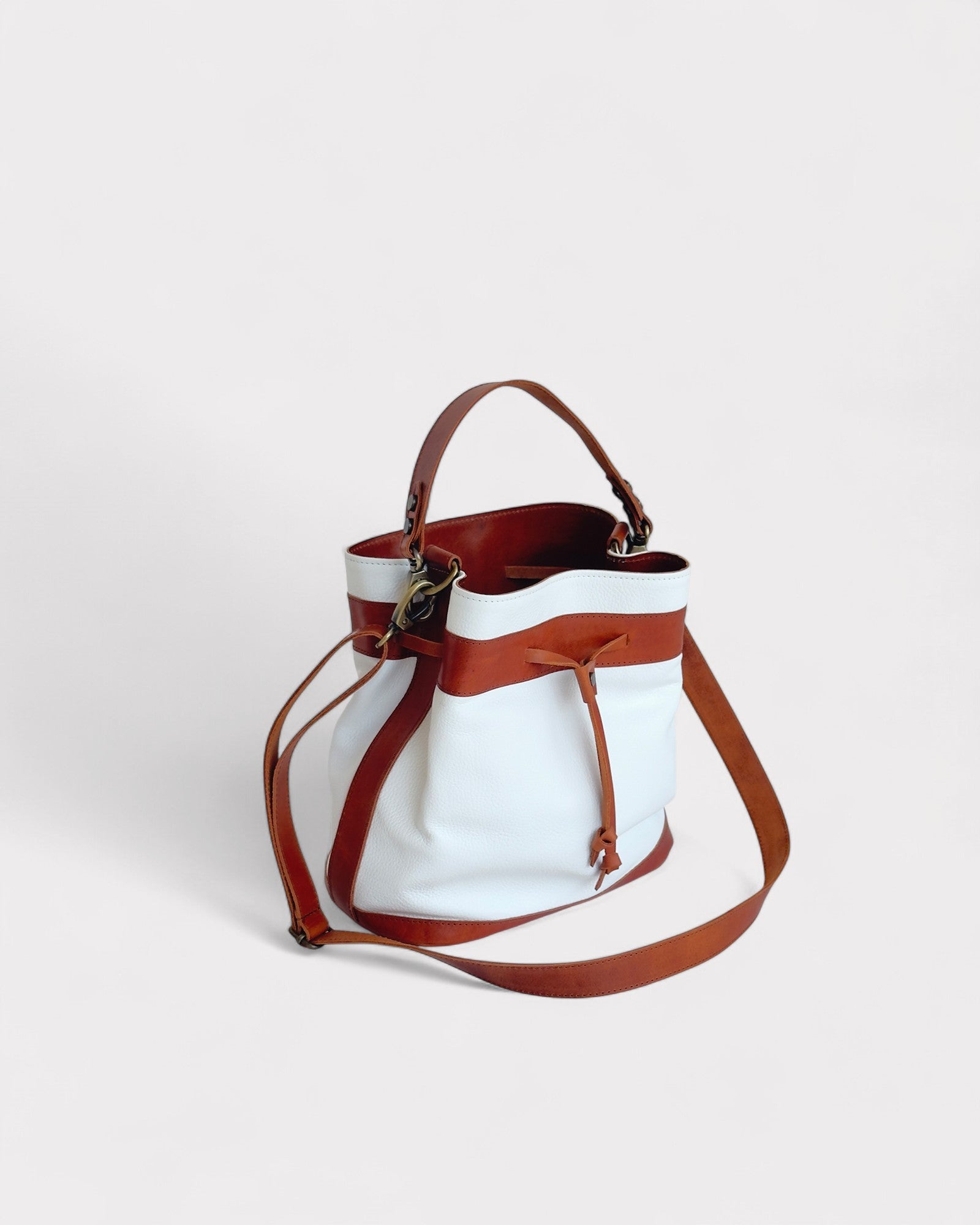 White and brown bucket on a light gray background