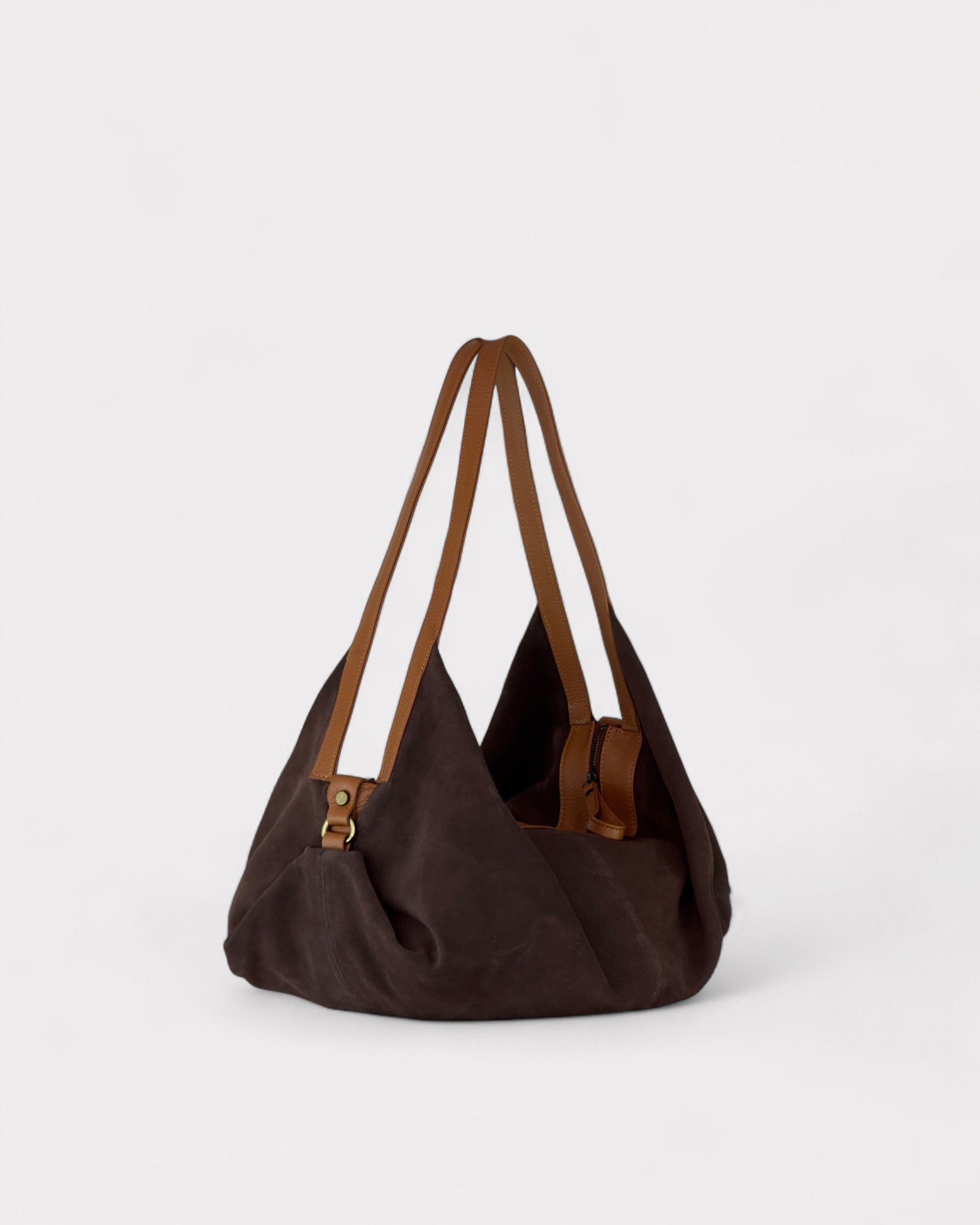 Brown handbag with leather straps on a light gray background