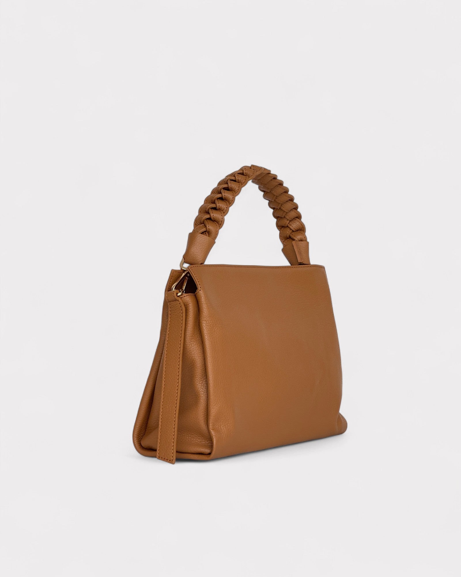 Tan handbag with braided handle on a light gray background