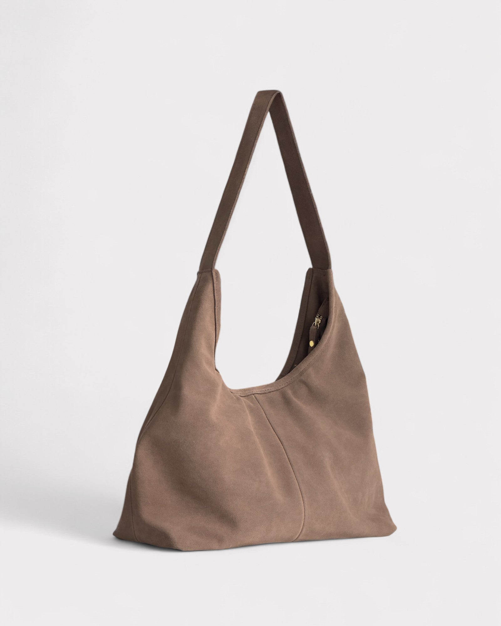 Taupe leather handbag on a light gray background