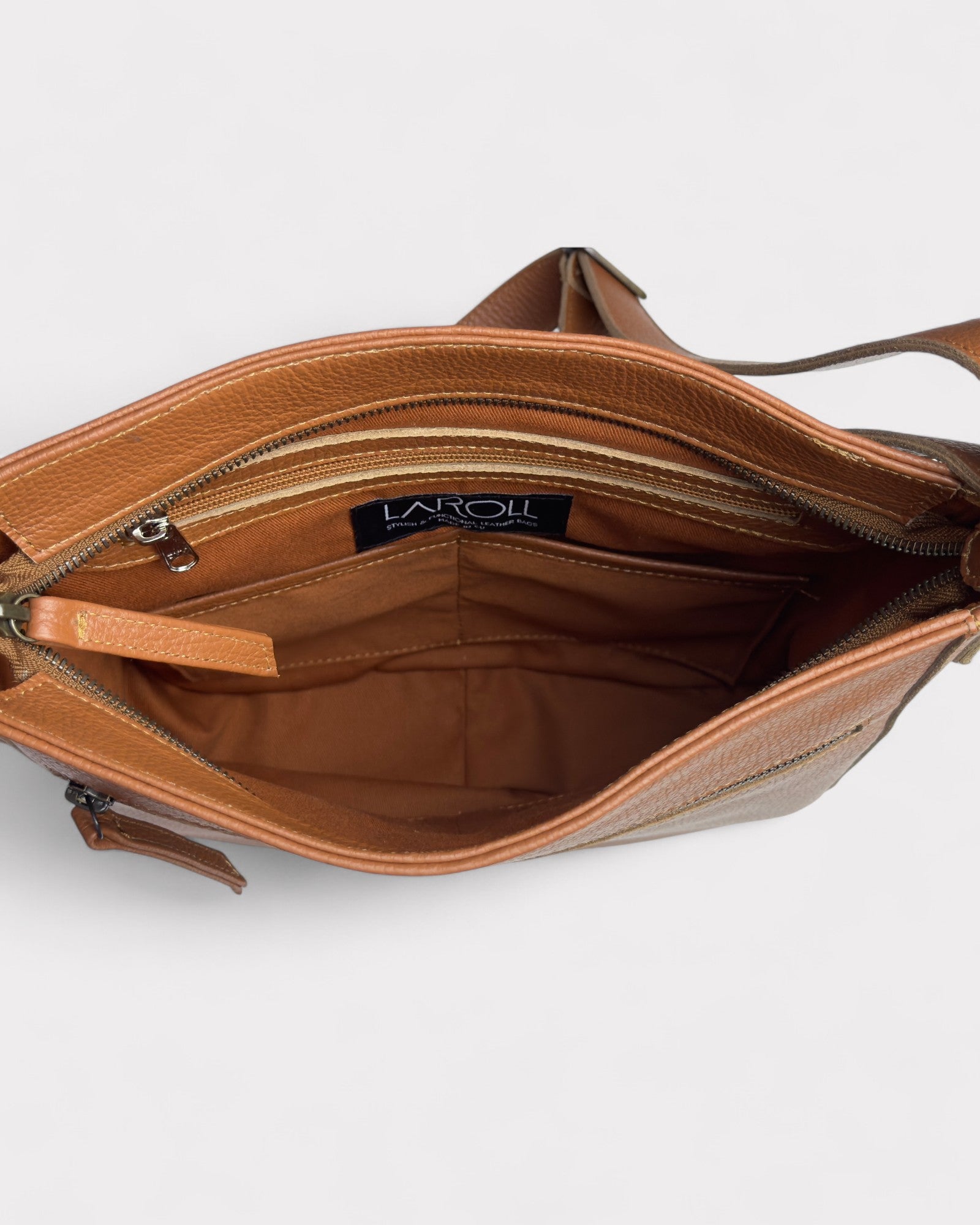 Tan leather handbag with visible brand logo on a light gray background