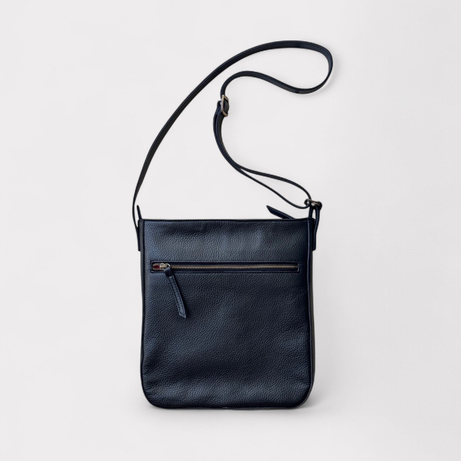 Black leather crossbody bag on a light gray background