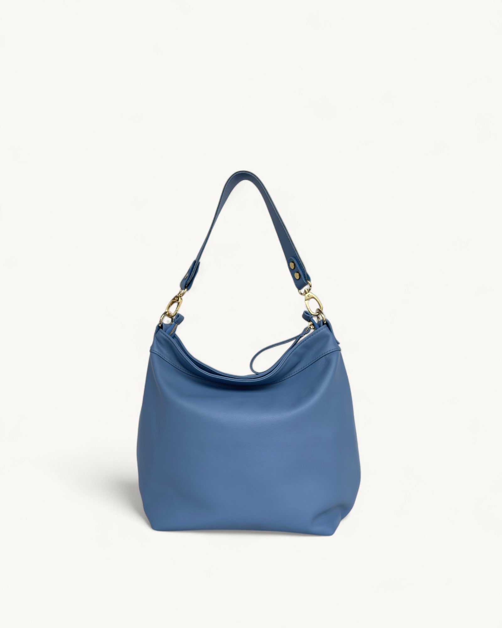 Blue handbag with a strap on a light gray background