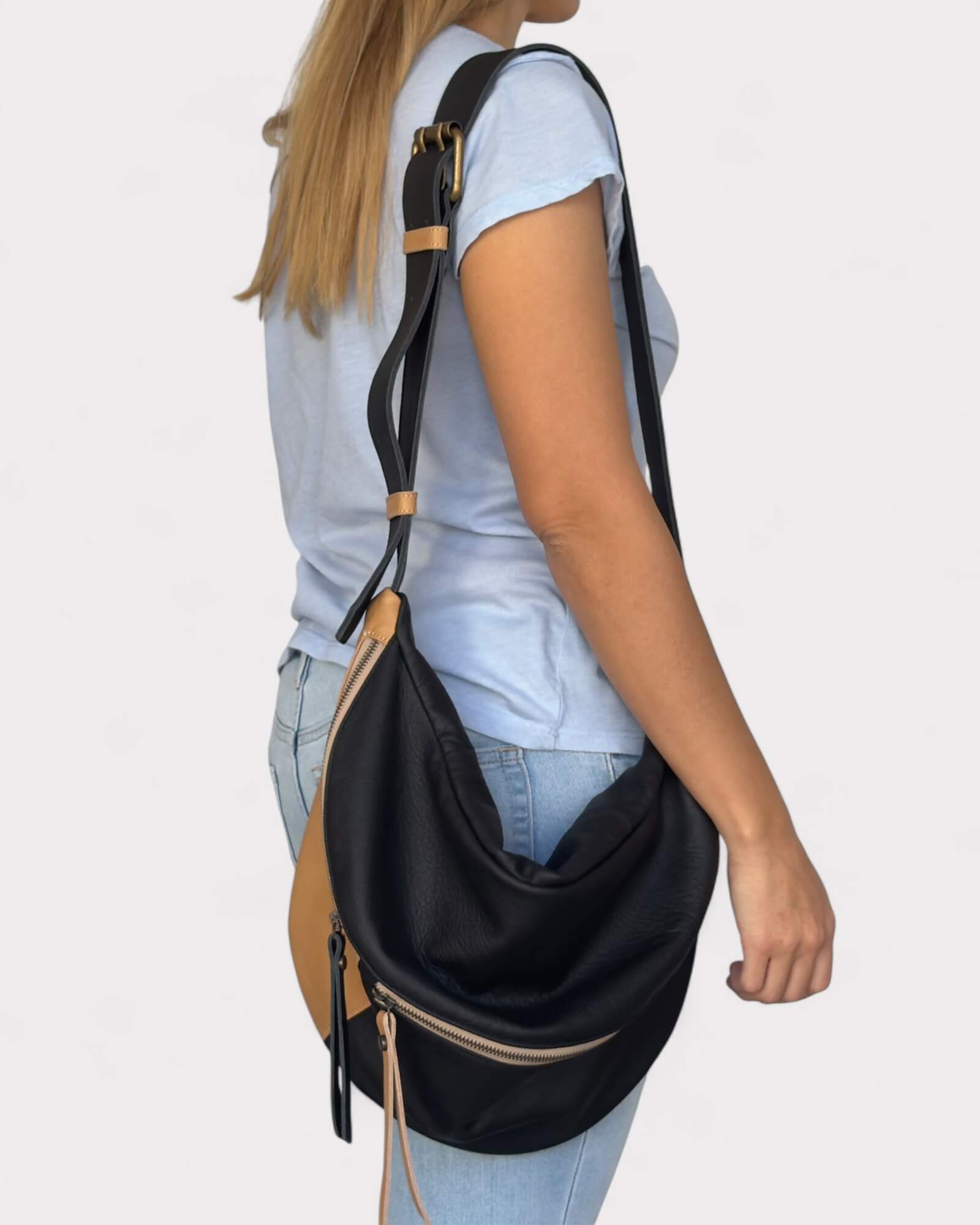 Person wearing a black and tan bag 