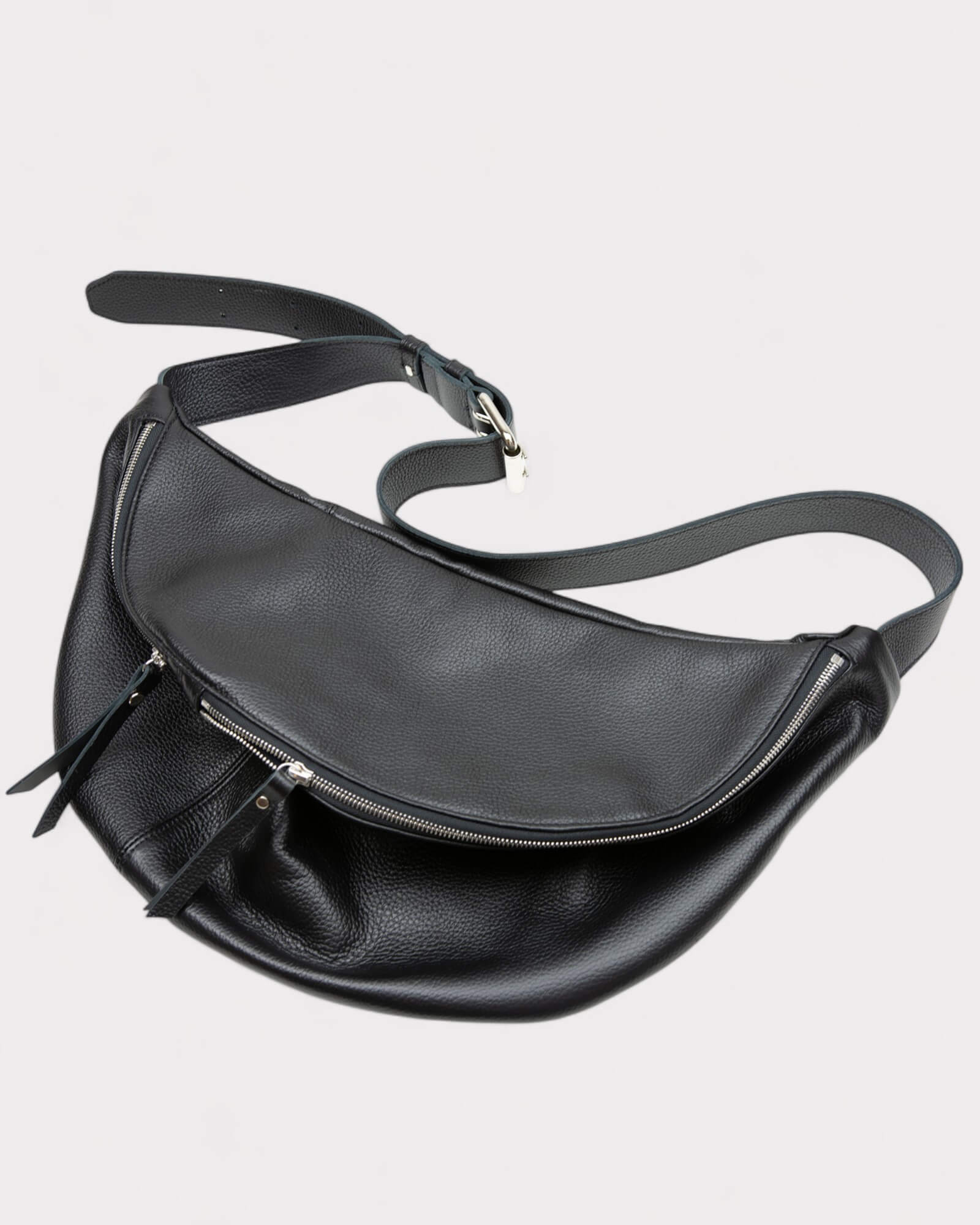 Black leather waist bag on a light gray background