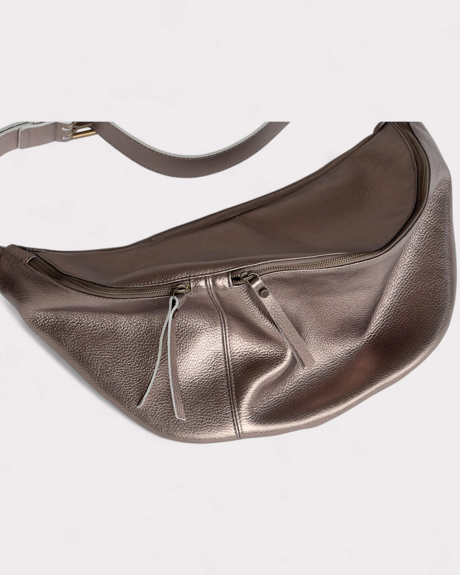 Metallic silver waist bag on a light gray background