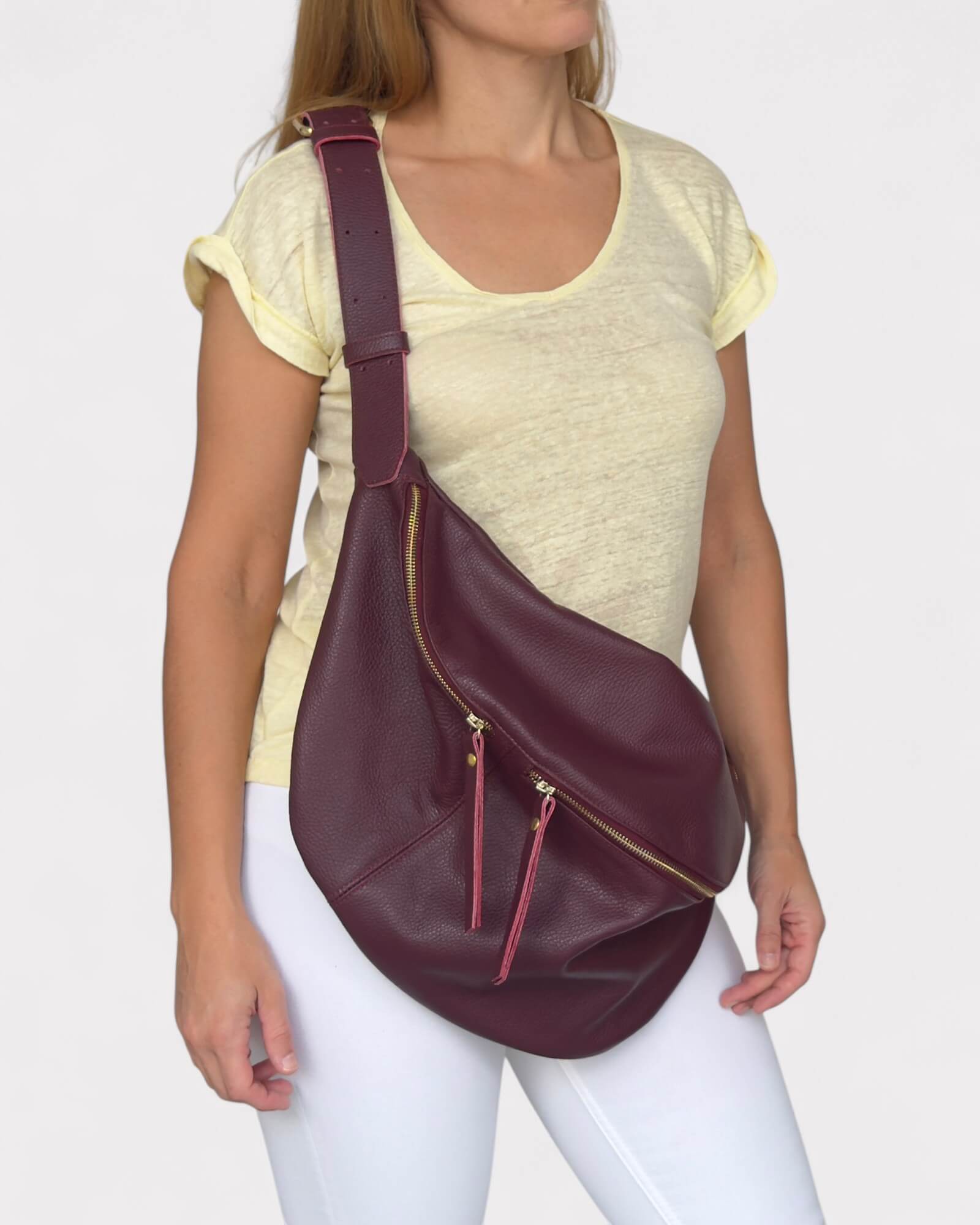 Woman wearing a maroon leather sling bag 