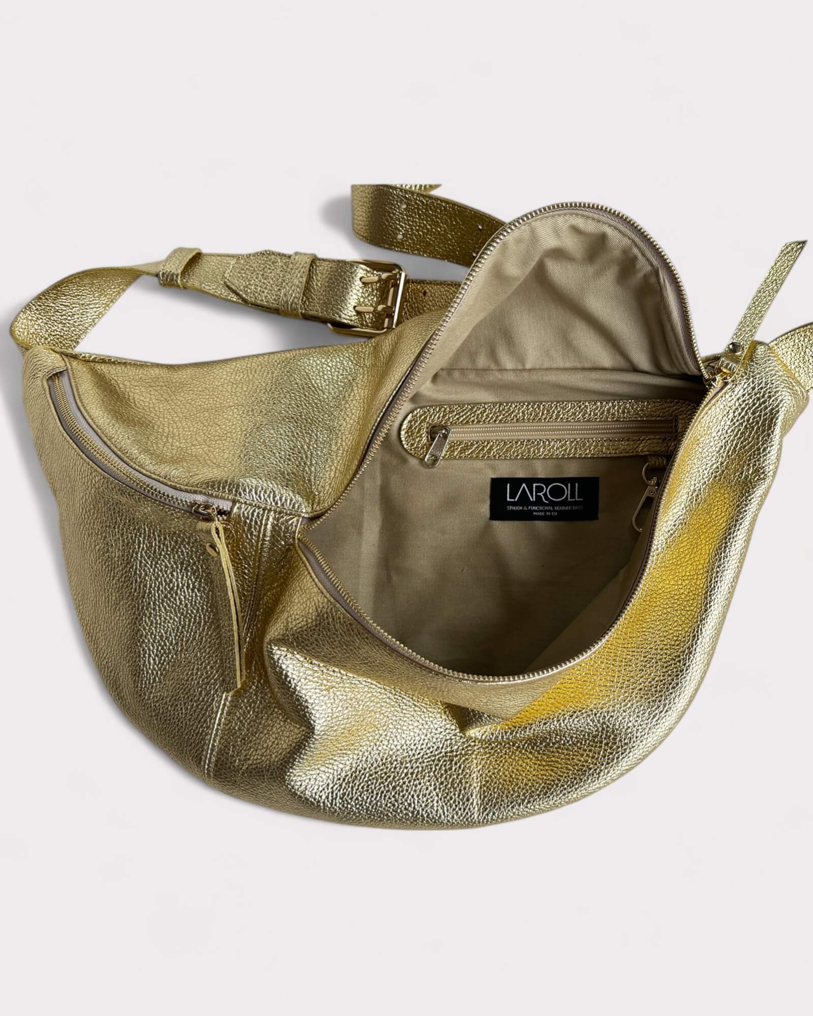 Gold metallic bag with open front pocket on a light gray background