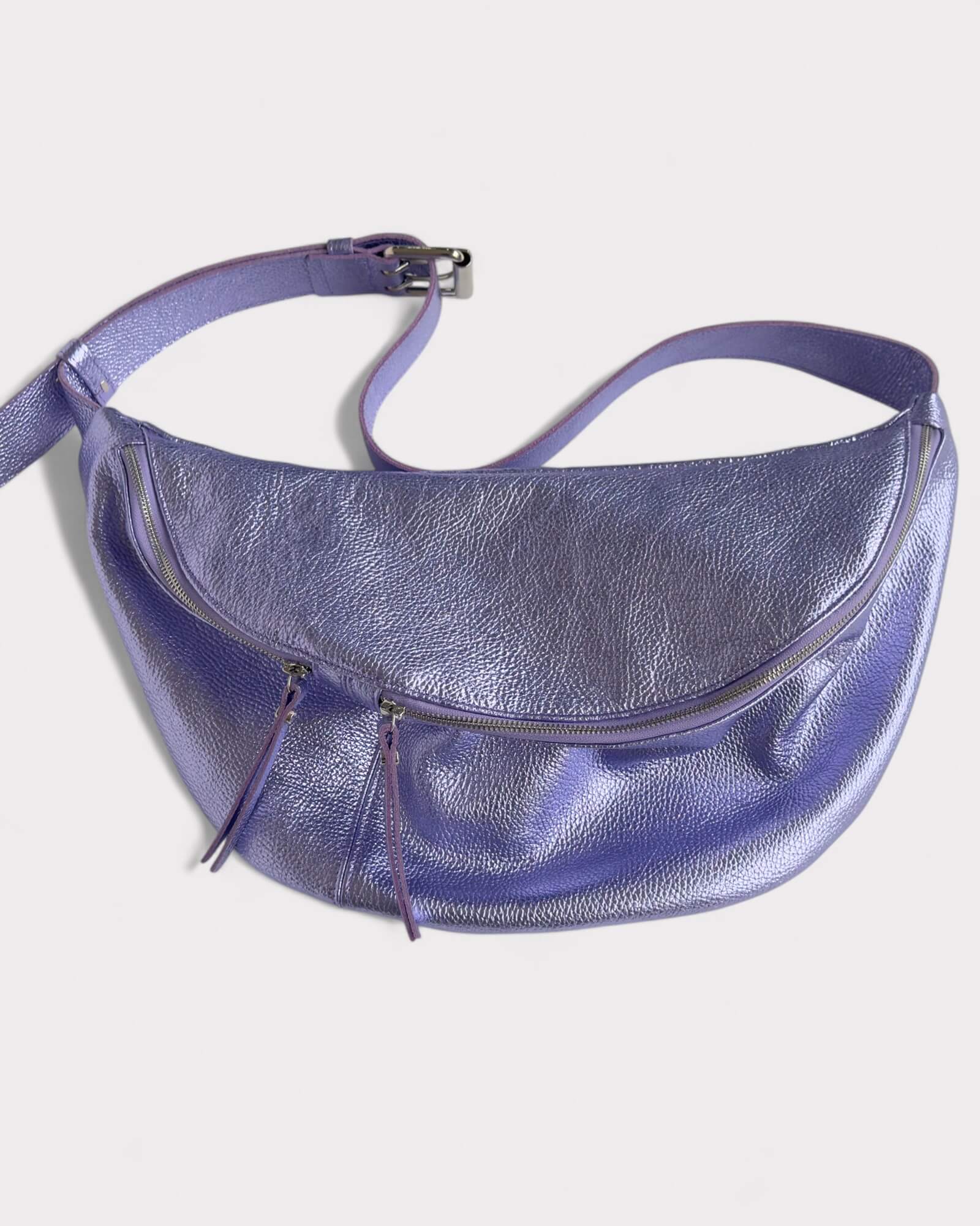 Purple metallic fanny pack on a white background