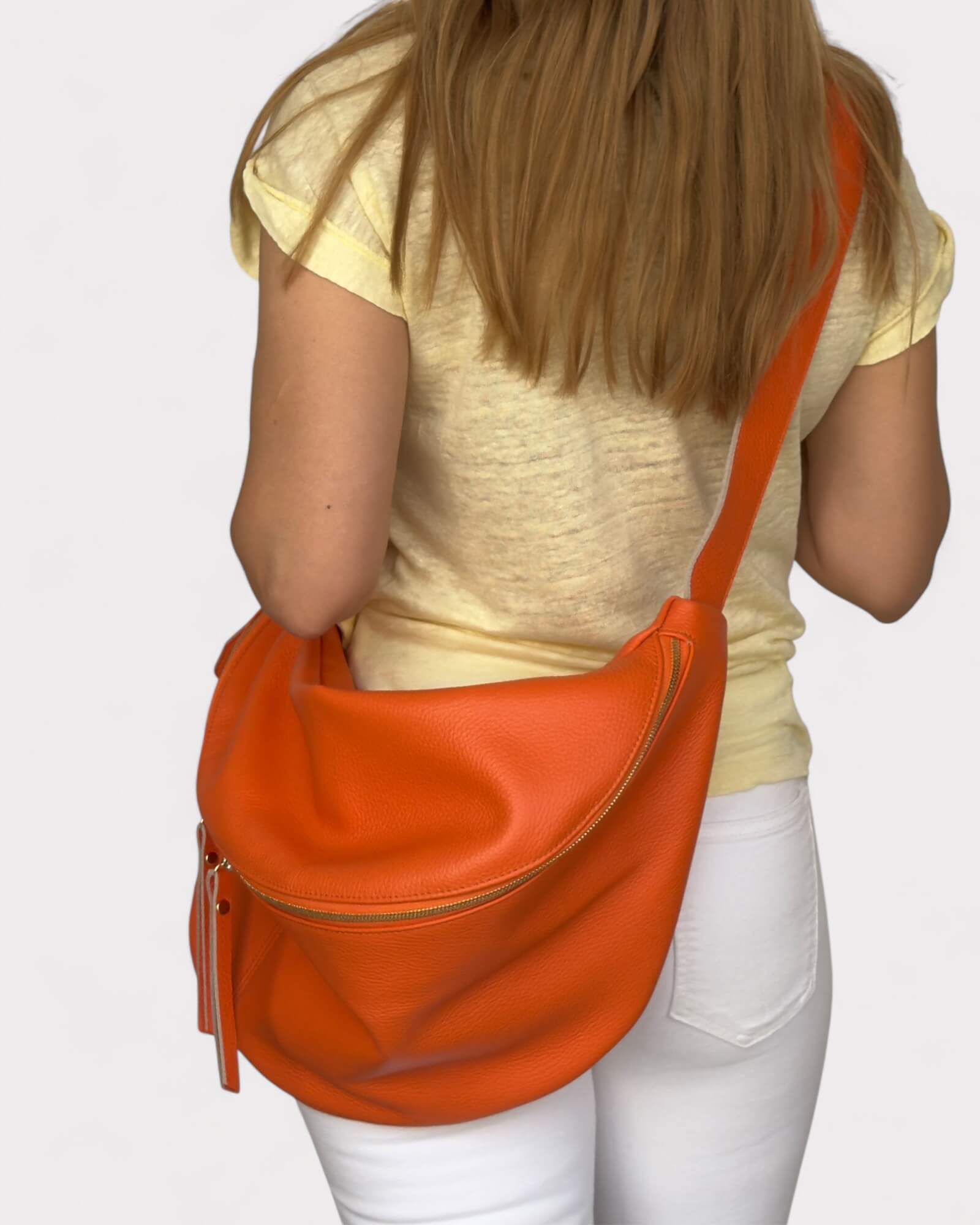 Model wearing an orange fanny pack