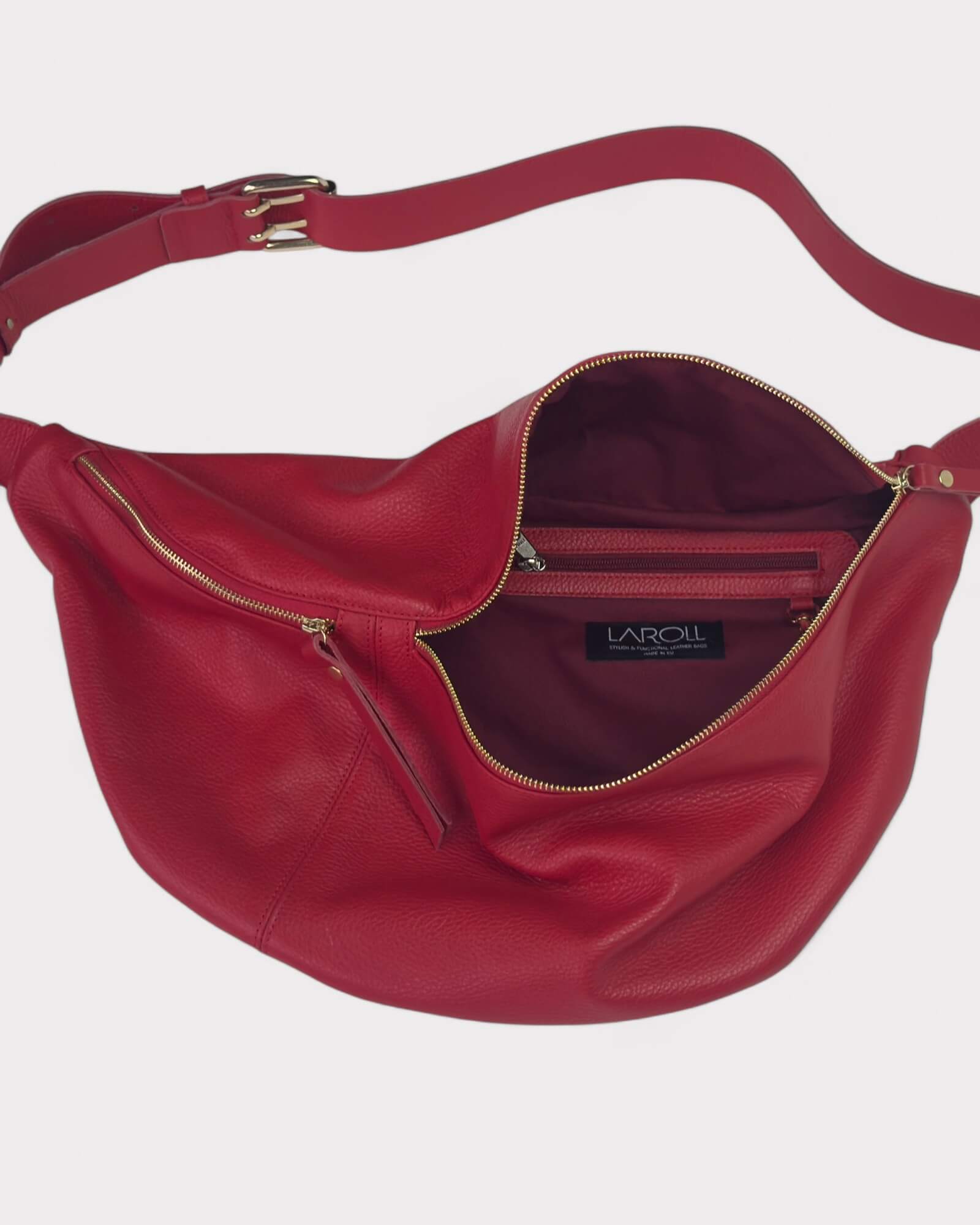 Red sling bag with gold zipper and visible brand logo on a white background