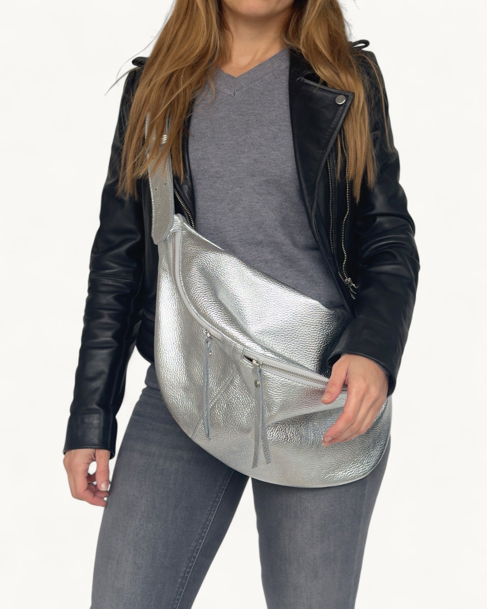 Person wearing  a silver crossbody bag on a white background