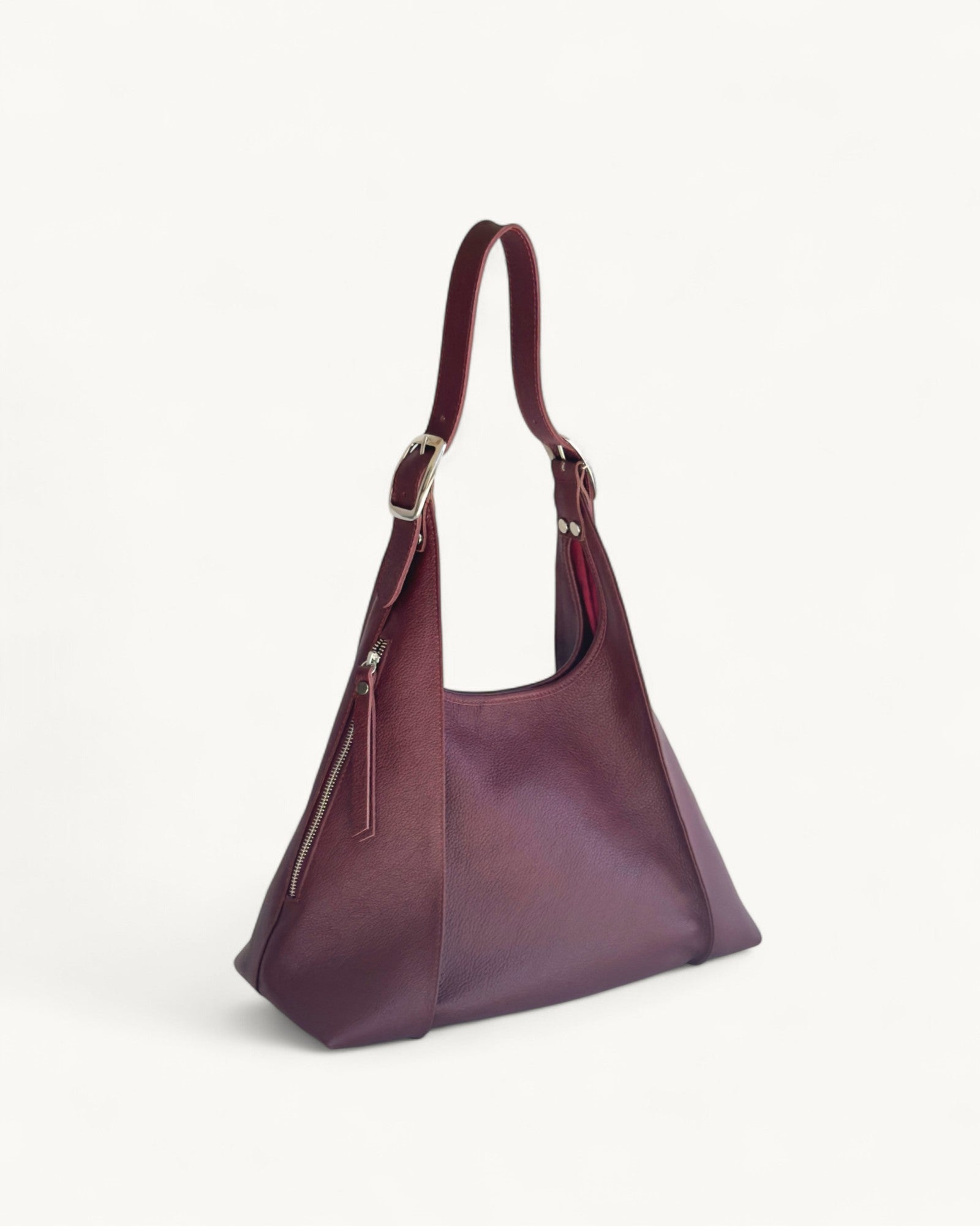 Burgundy handbag on a light gray background