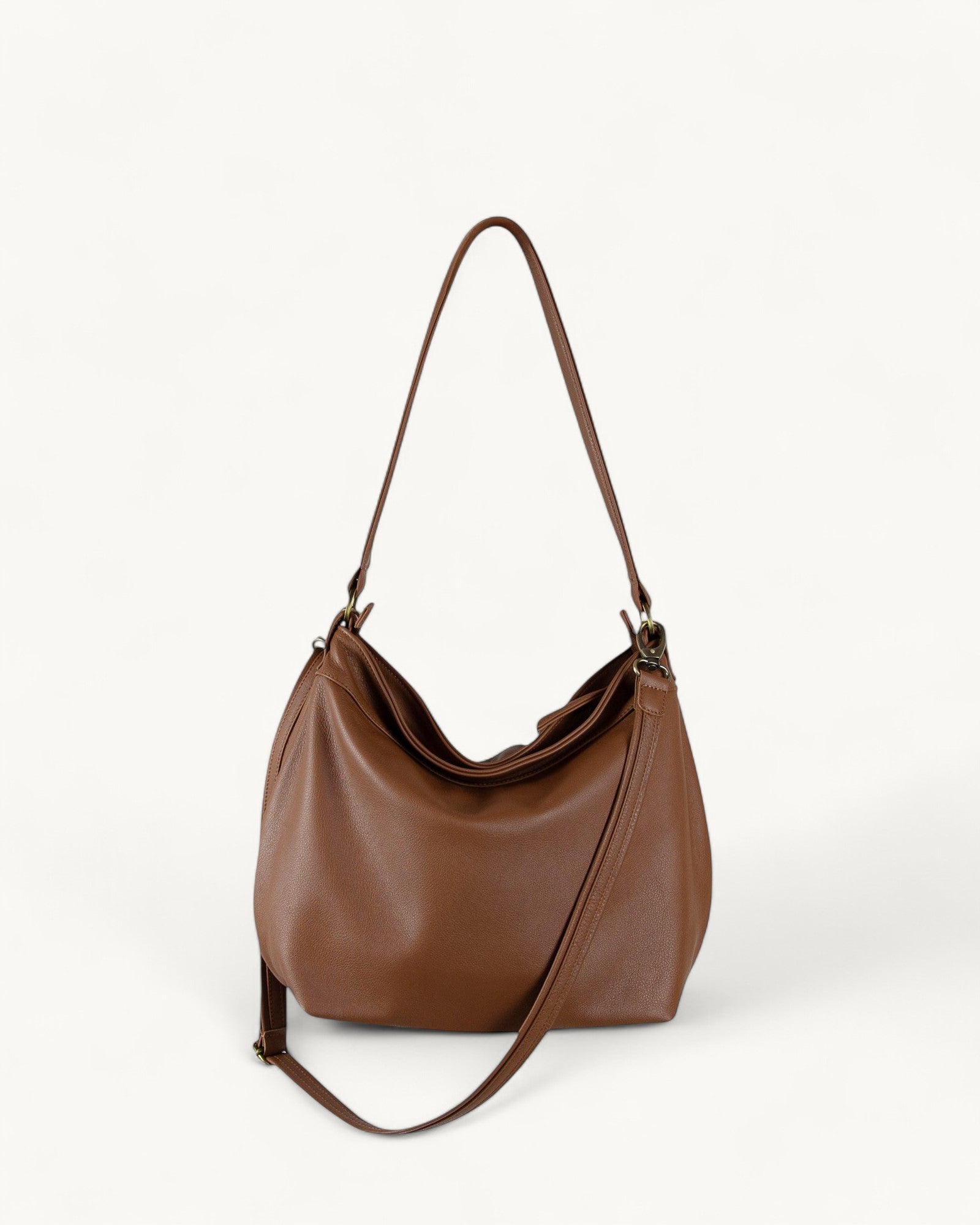 Cognac brown leather handbag on a white background