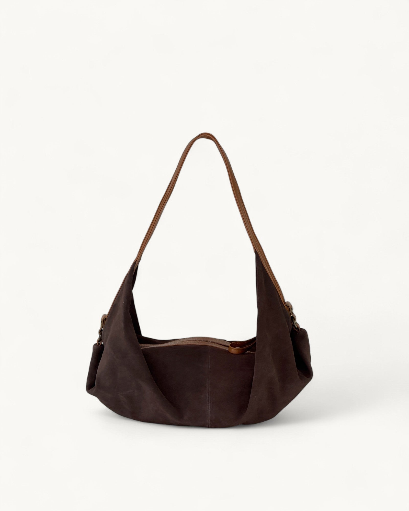 Brown leather handbag on a light beige background