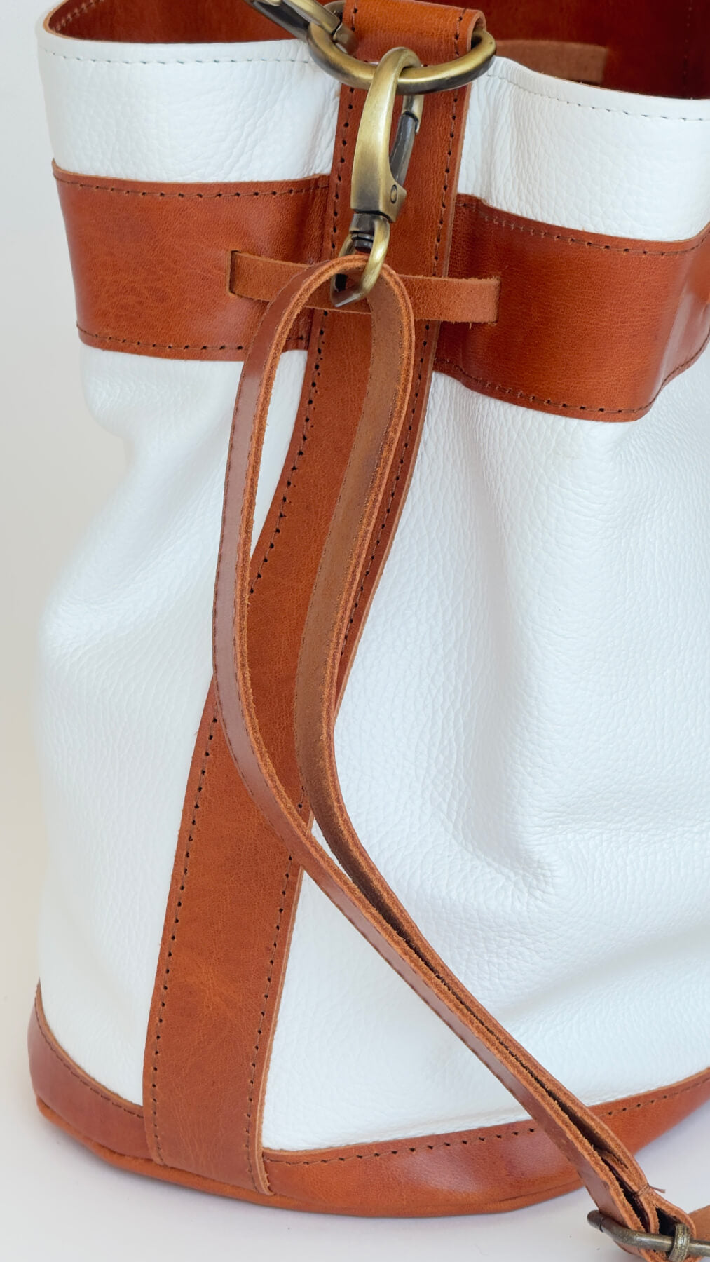 detail of white leather bucket bag