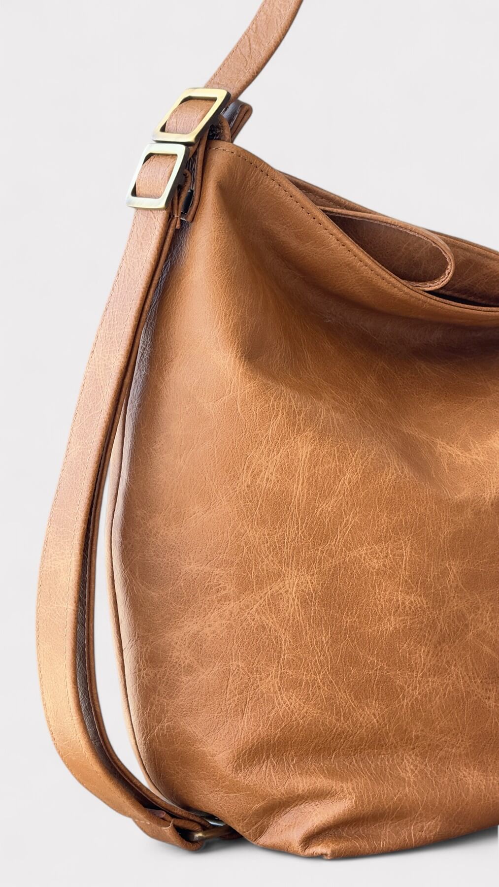 Tan leather handbag side view