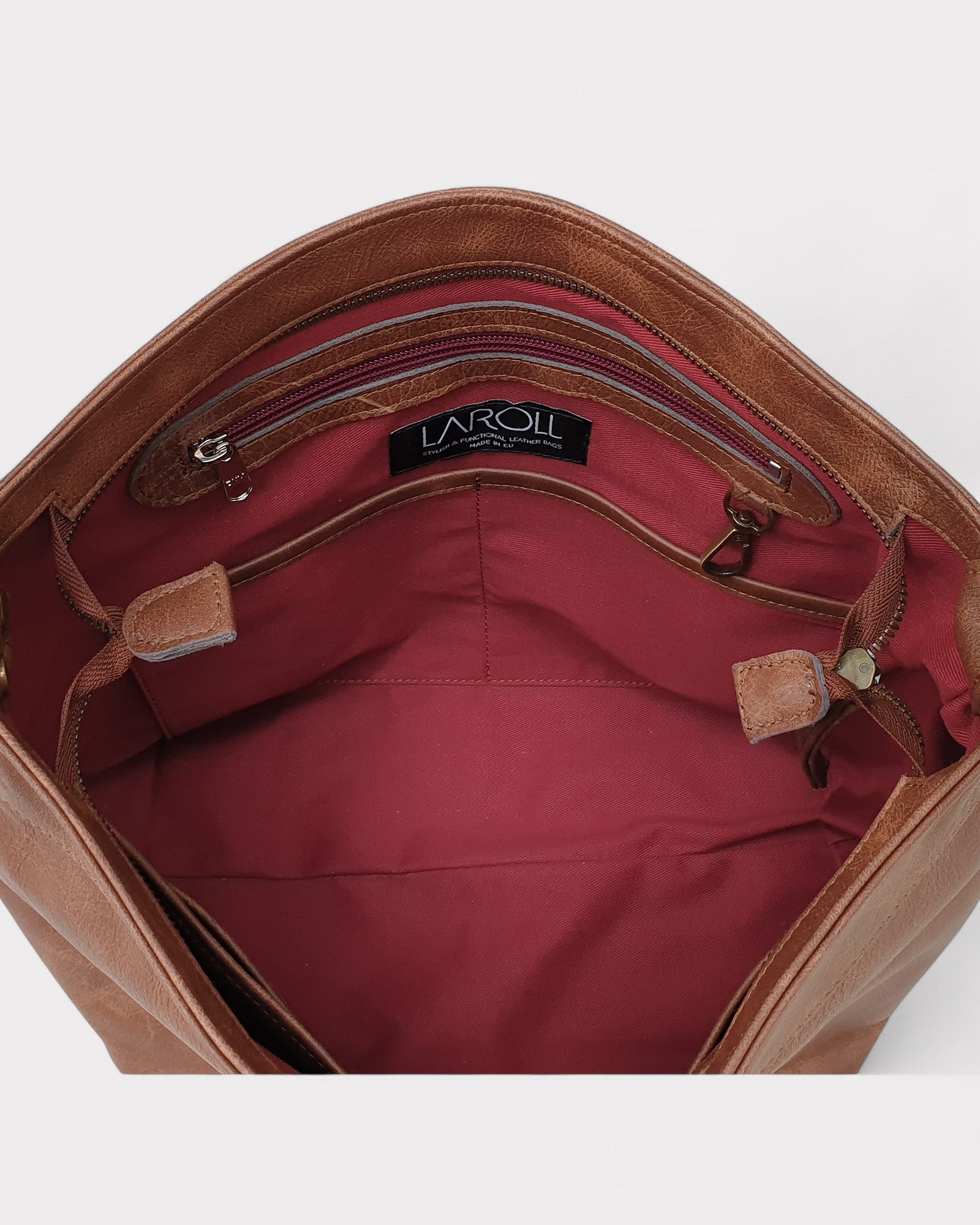 Brown leather bag with visible brand logo on a white background
