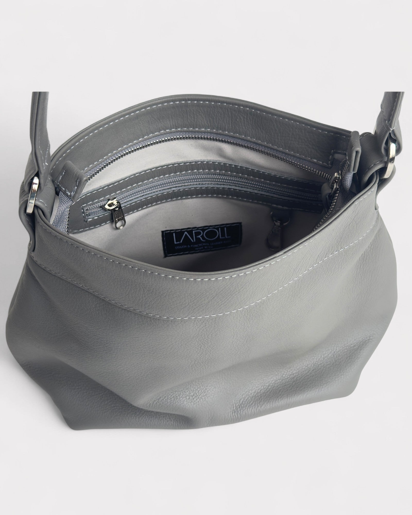 Gray handbag with visible brand logo on a light gray background