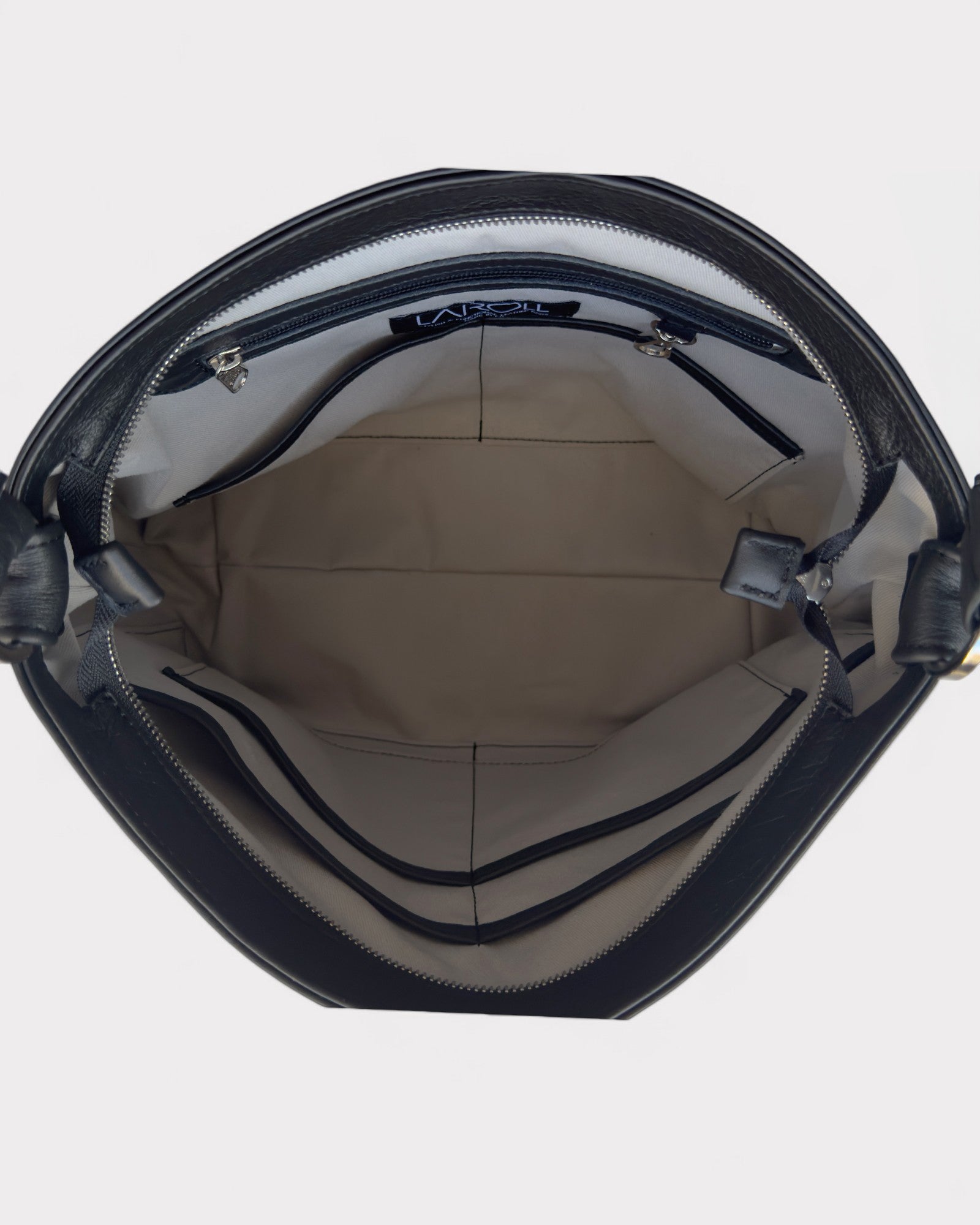 Inside view of a black handbag with grey interior on a white background