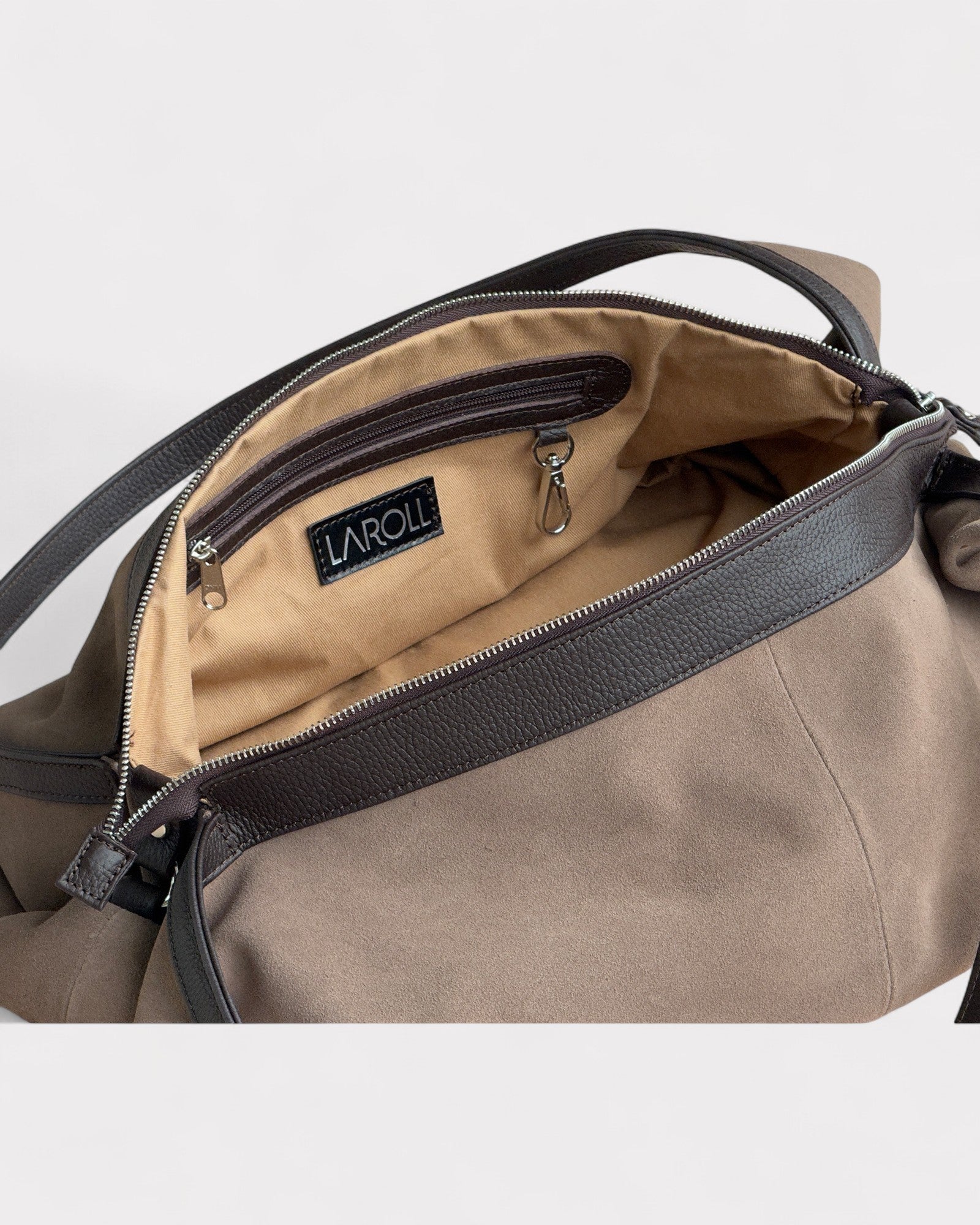 Taupe handbag with visible brand logo on a light gray background