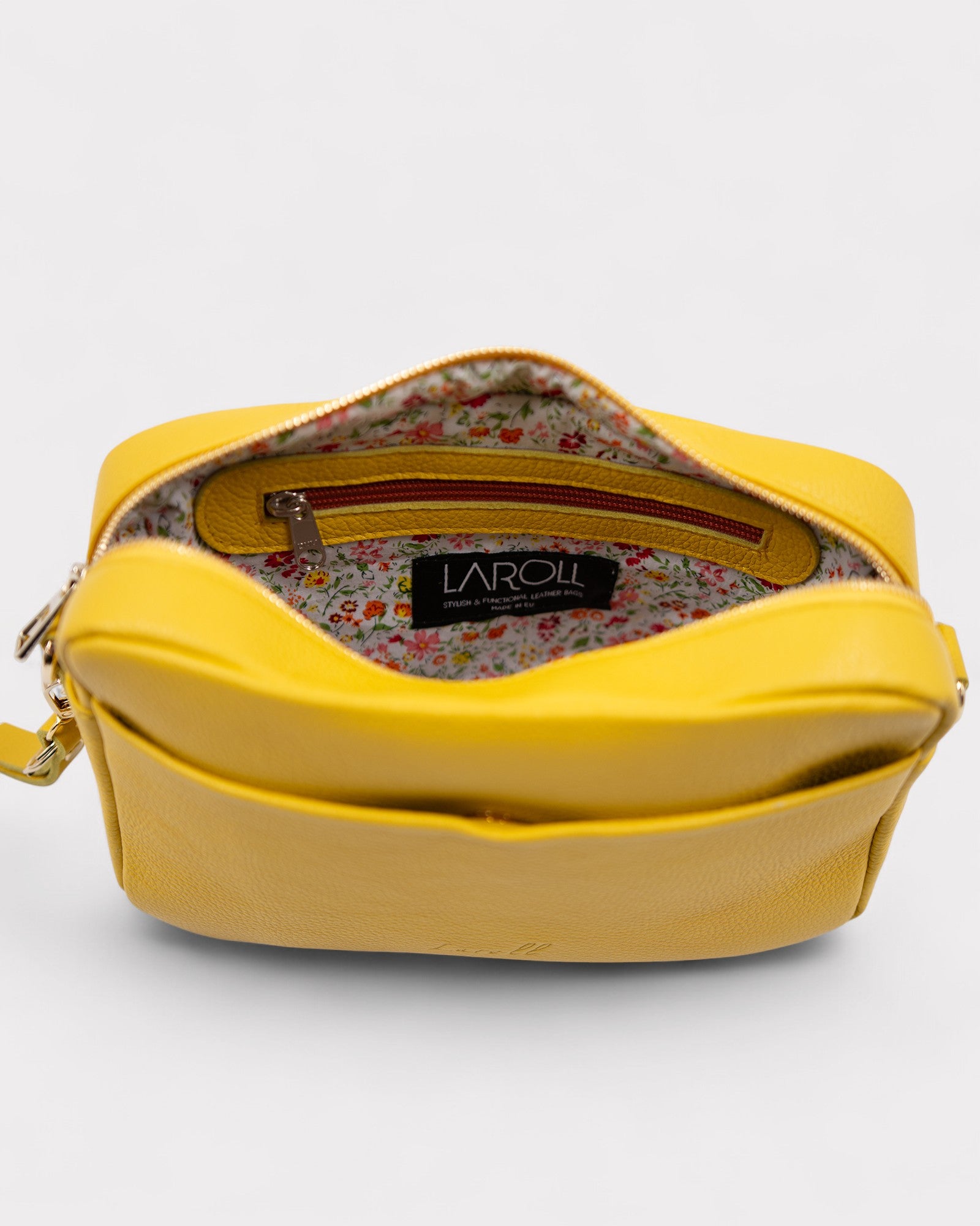 Yellow handbag with floral interior on a white background