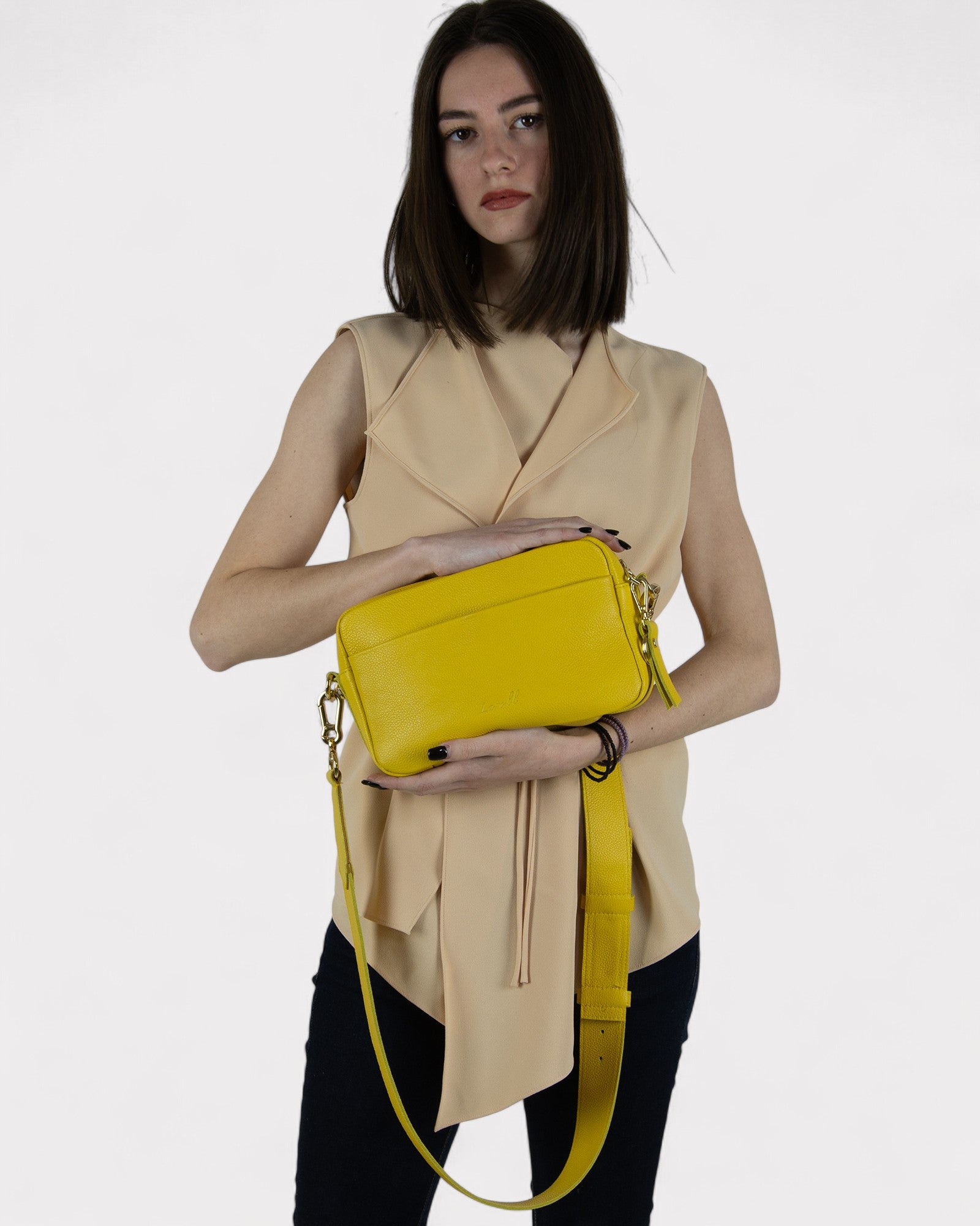 person wearing yellow camera bag