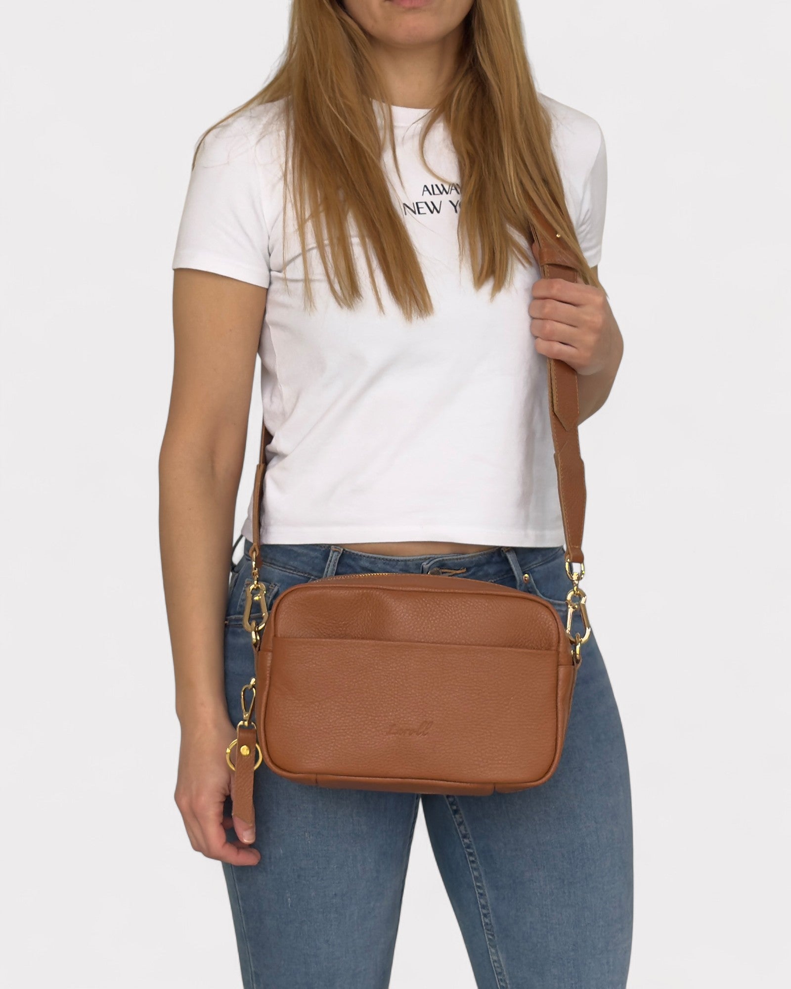 model wearing tan camera bag