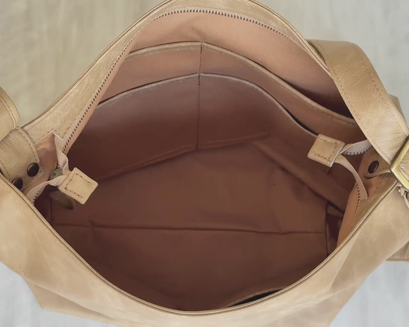 video of beige convertible hobo bag what it fits inside