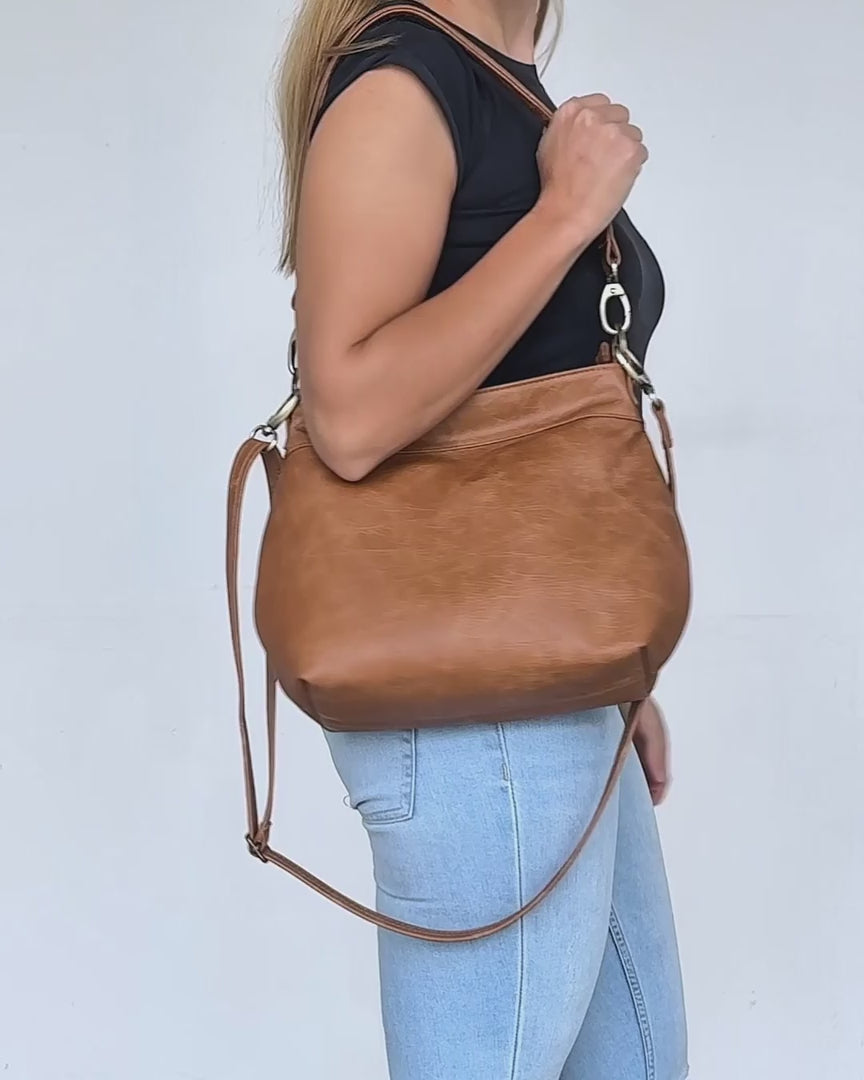 video of tan distressed small leather hobo bag